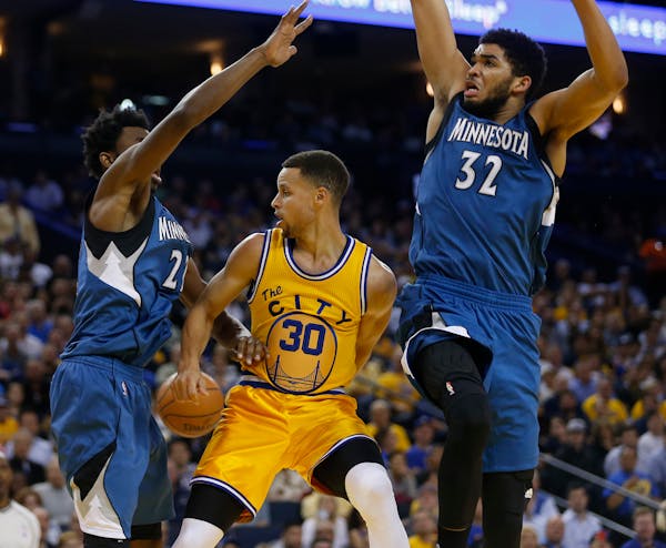 The Wolves' Andrew Wiggins (left) and Karl-Anthony Towns (right) -- shown guarding Golden State's Stephen Curry in an April 2016 game -- have set fran