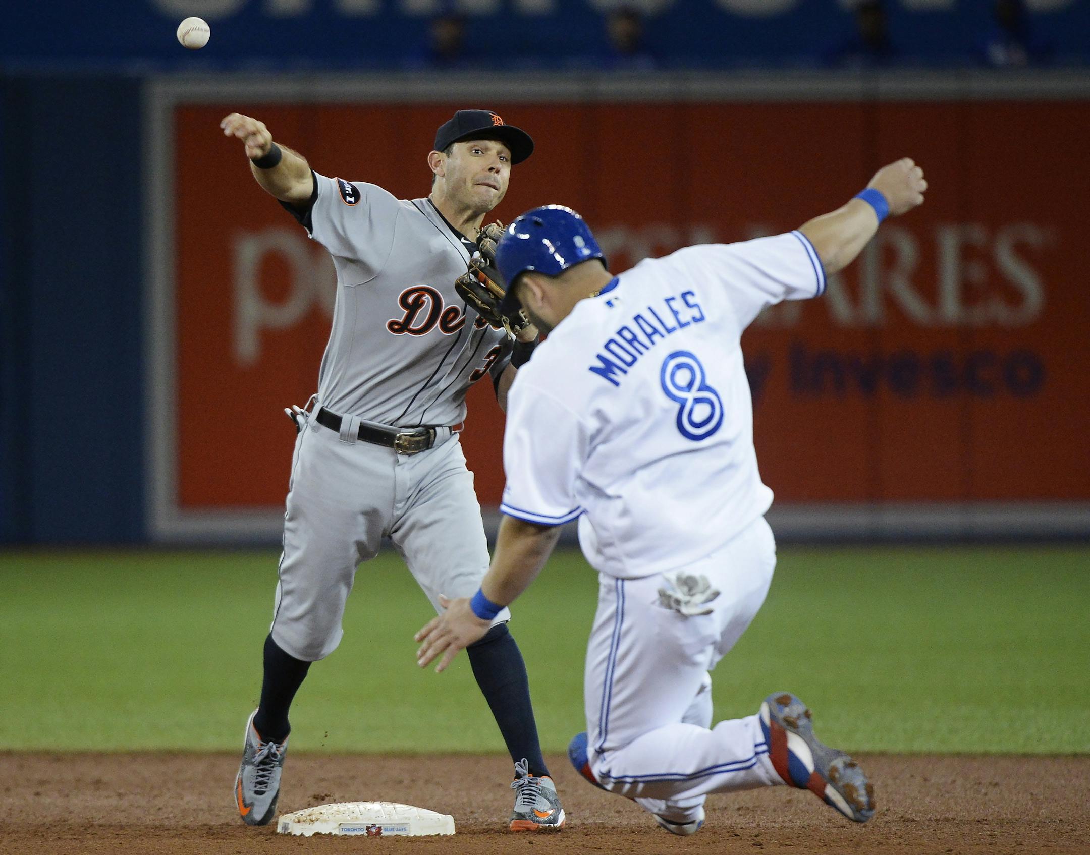 Detroit Tigers second baseman Ian Kinsler throws to first after forcing out Toronto Blue Jays' Kendrys Morales (8) to complete a triple play on a ball hit by Kevin Pillar during the sixth inning of a baseball game in Toronto on Friday, Sept. 8, 2017. (Nathan Denette/The Canadian Press via AP)