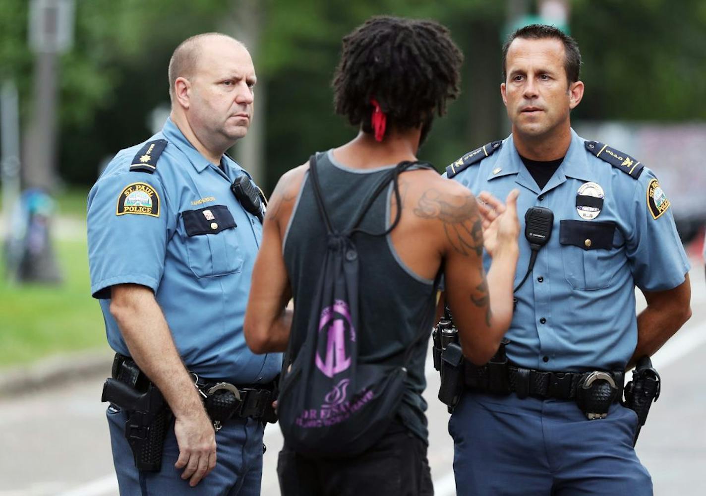 Protester Jabob Ladda, center, negotiates peacefully with St. Paul Police East Patrol commander Steve Anderson, left, and St. Paul Police senior commander Tim Flynn, right, in front of the Governor's residence in St. Paul on July 11.