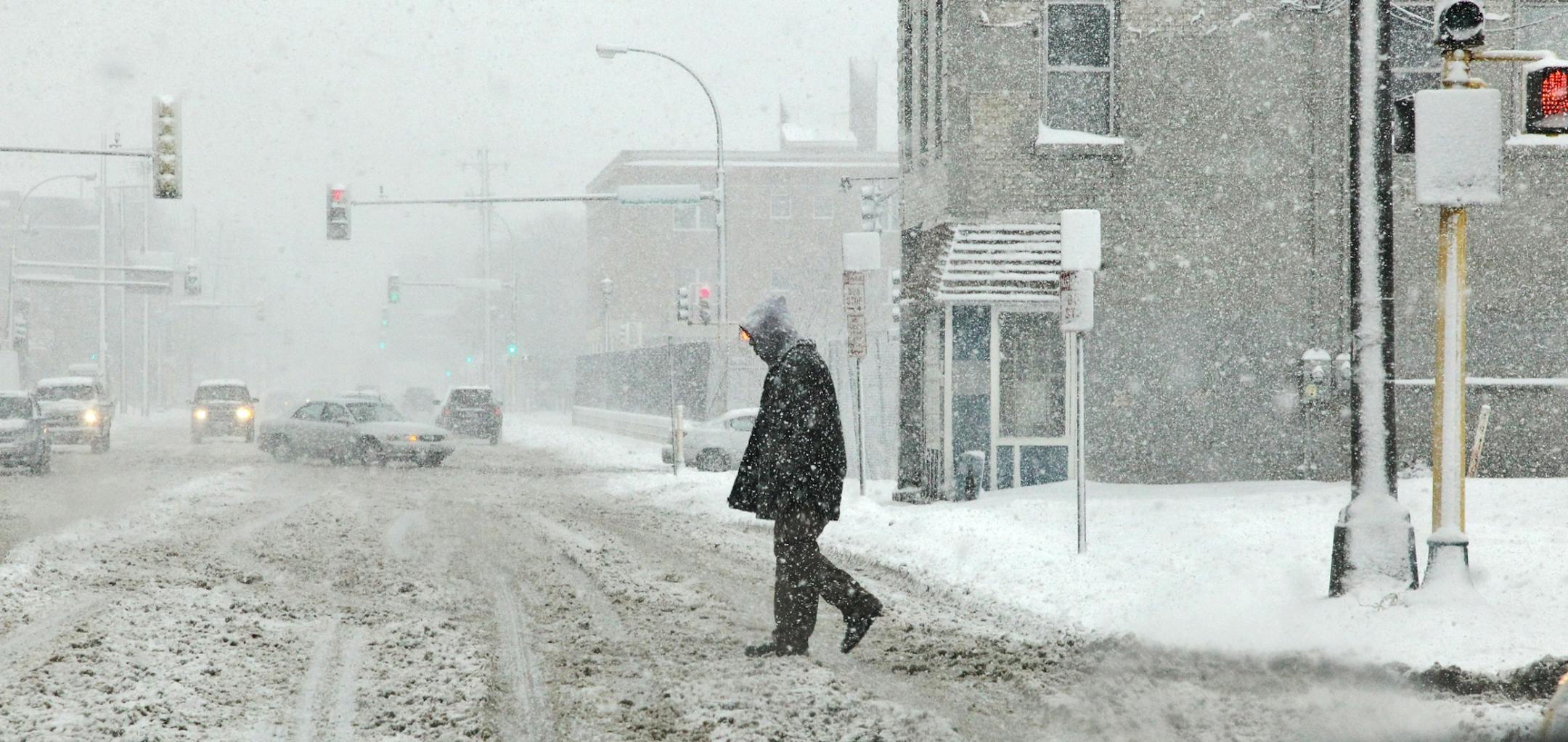 Snow storm in Twin Cities. A pedestrian found it tough going crossing Franklin Ave. near downtown Minneapolis.