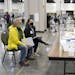Election workers, right, verify ballots as recount observers, left, watch during a Milwaukee hand recount of presidential votes at the Wisconsin Cente