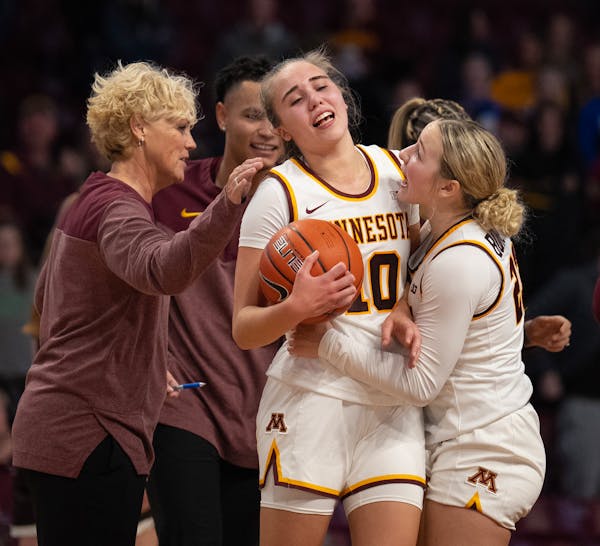 Gophers guard Katie Borowicz (23) celebrated with guard Mara Braun (10) after her game-winning shot as time ran out in the fourth quarter of their gam