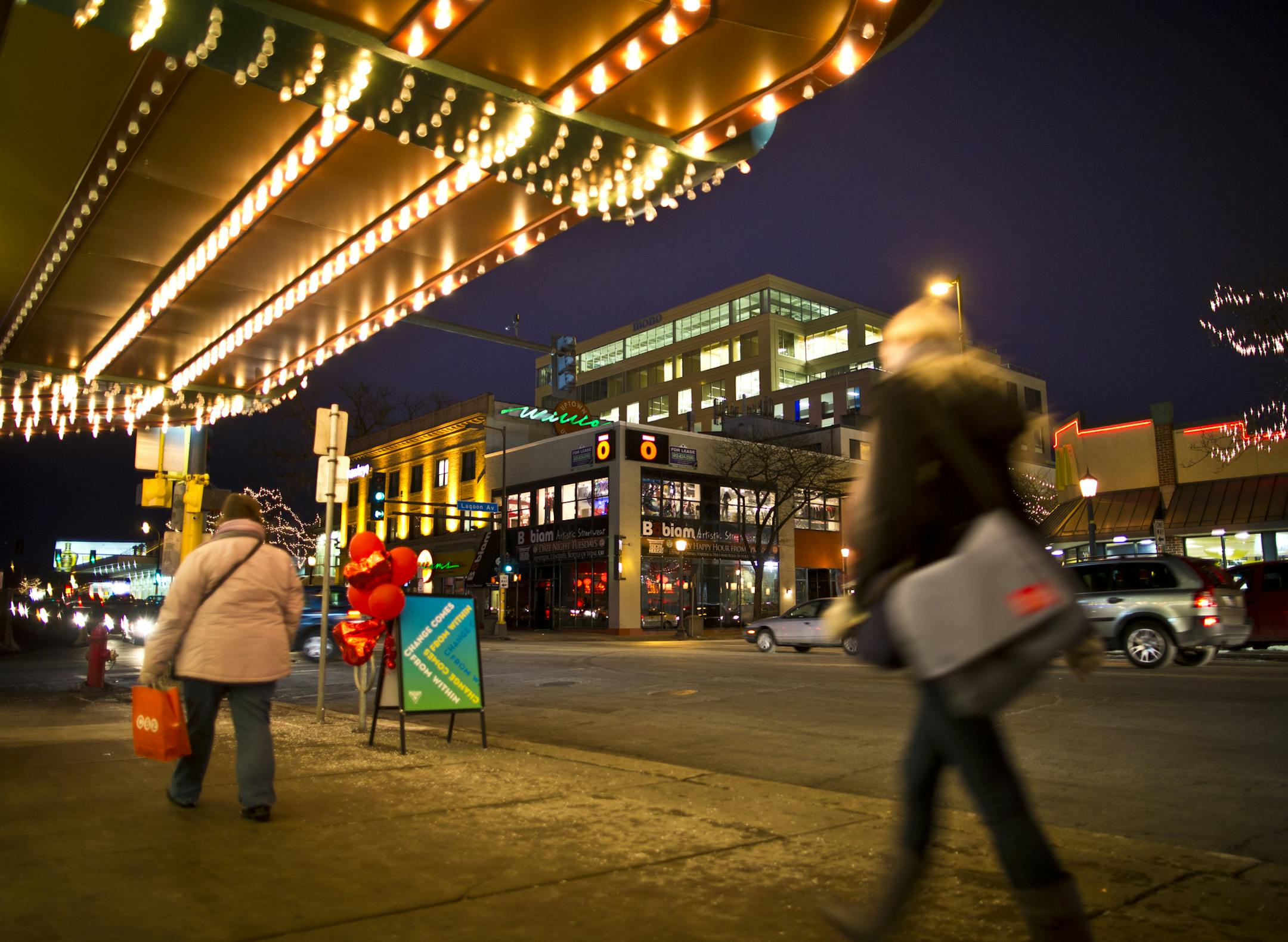 People walked under the Uptown theater marquee with a view of the 10 story MoZaic building in Uptown on Thursday, February 21, 2013, Minneapolis.