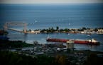 A shipping vessel navigated through Duluth's Harbor before heading out into Lake Superior Wednesday night. ] AARON LAVINSKY • aaron.lavinsky@startri
