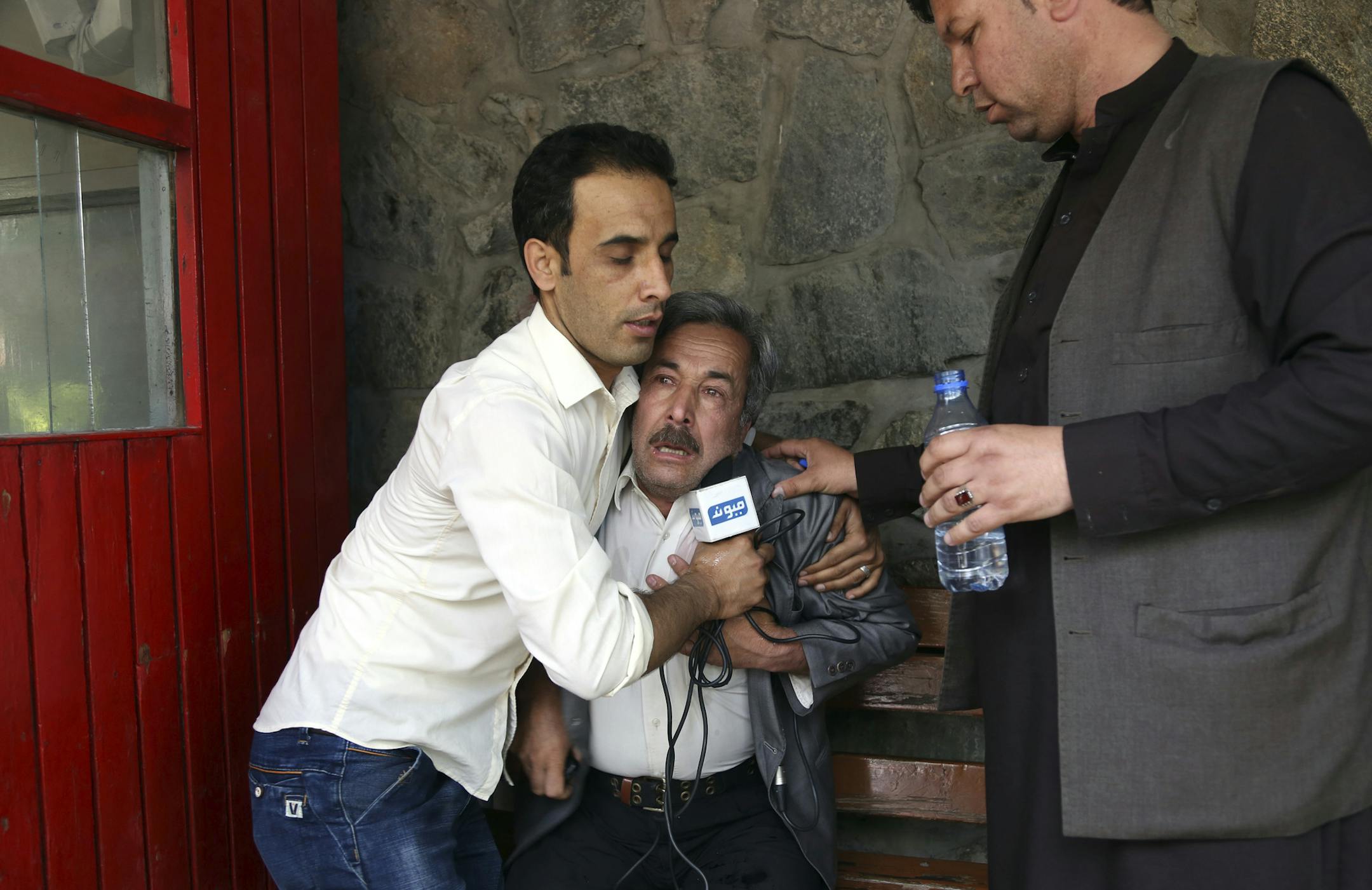 A man cries at a hospital after he lost his Journalist son in explosions in Kabul, Afghanistan, Monday, April 30, 2018. A coordinated double suicide bombing hit central Kabul on Monday morning, (AP Photo/Rahmat Gul)