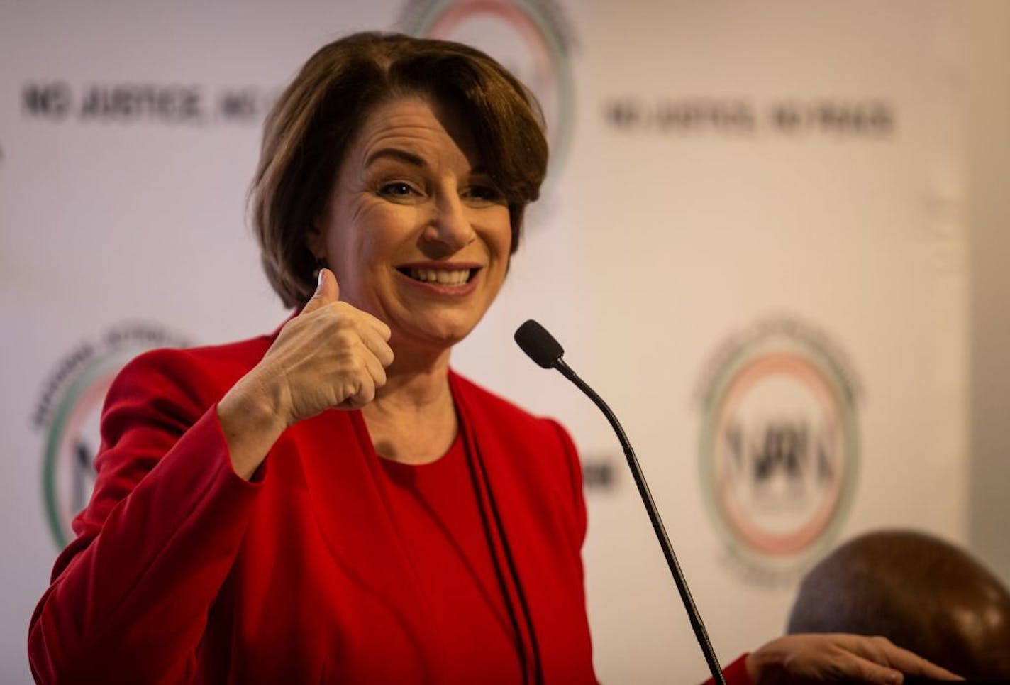 Amy Klobuchar gestures to an audience at a breakfast event on Thursday, Nov. 21, 2019, in Atlanta. Klobuchar, along with Pete Buttigieg, Cory Booker, Andrew Yang and Tom Steyer, all presidential hopefuls, spoke at the event hosted by the Al Sharpton's National Action Network.