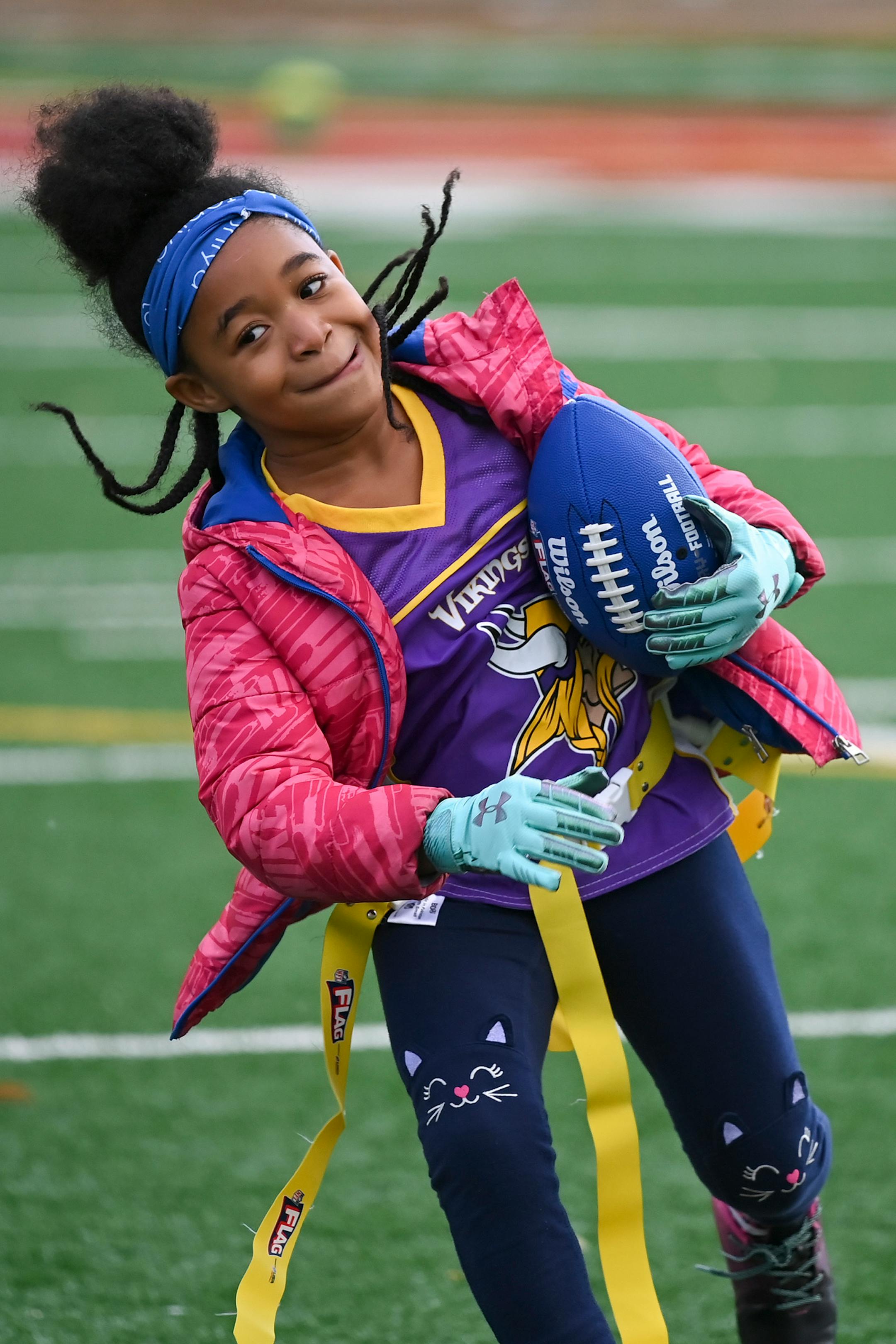 Toniya Farmer, 8, ran the football during a flag football practice Wednesday night.