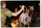 A common occurrence at Replacements shows, Bill Sullivan, right, took over vocals from Paul Westerberg as Slim Dunlap looked on during a late '80s gig