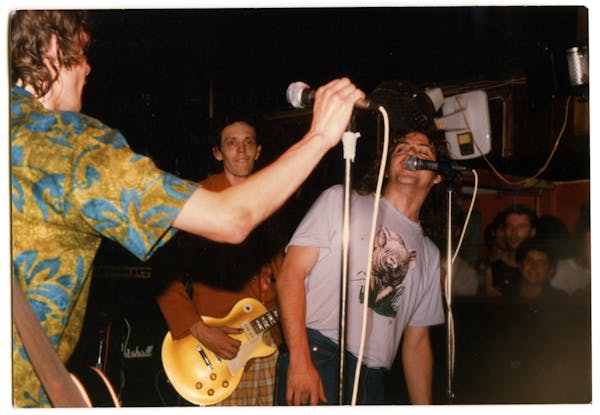 A common occurrence at Replacements shows, Bill Sullivan, right, took over vocals from Paul Westerberg as Slim Dunlap looked on during a late '80s gig