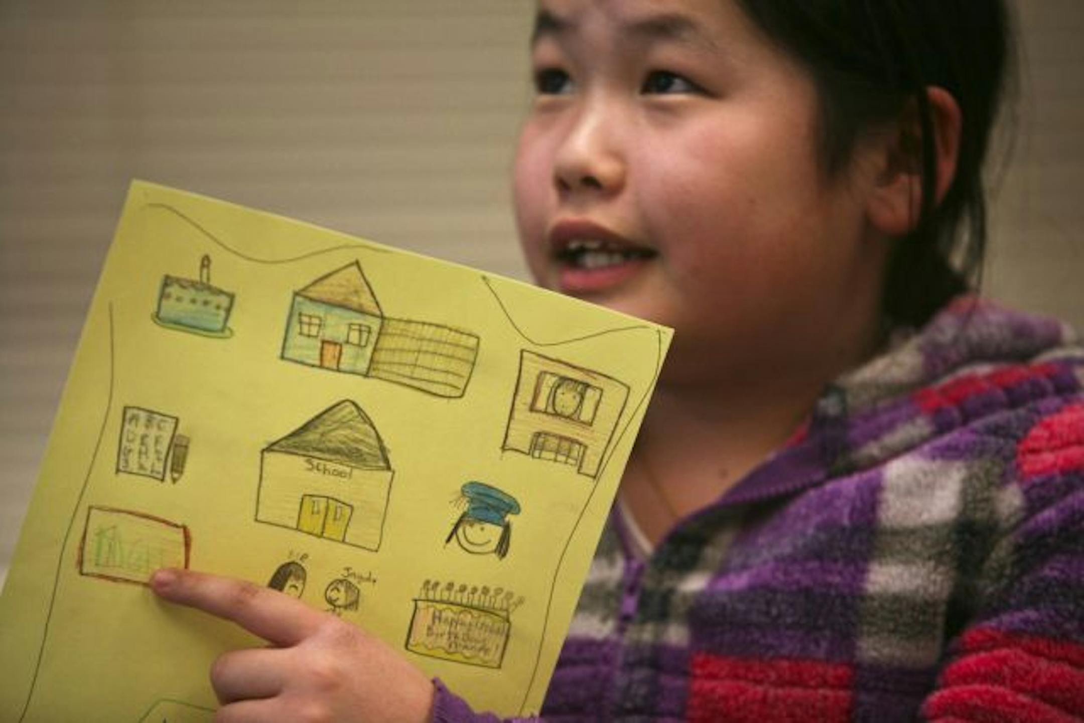 Fourth grader Manee Xiong held up her winter count and told what each picture represented each year of her life during the Young Scholars Program at Richardson Elementary School.