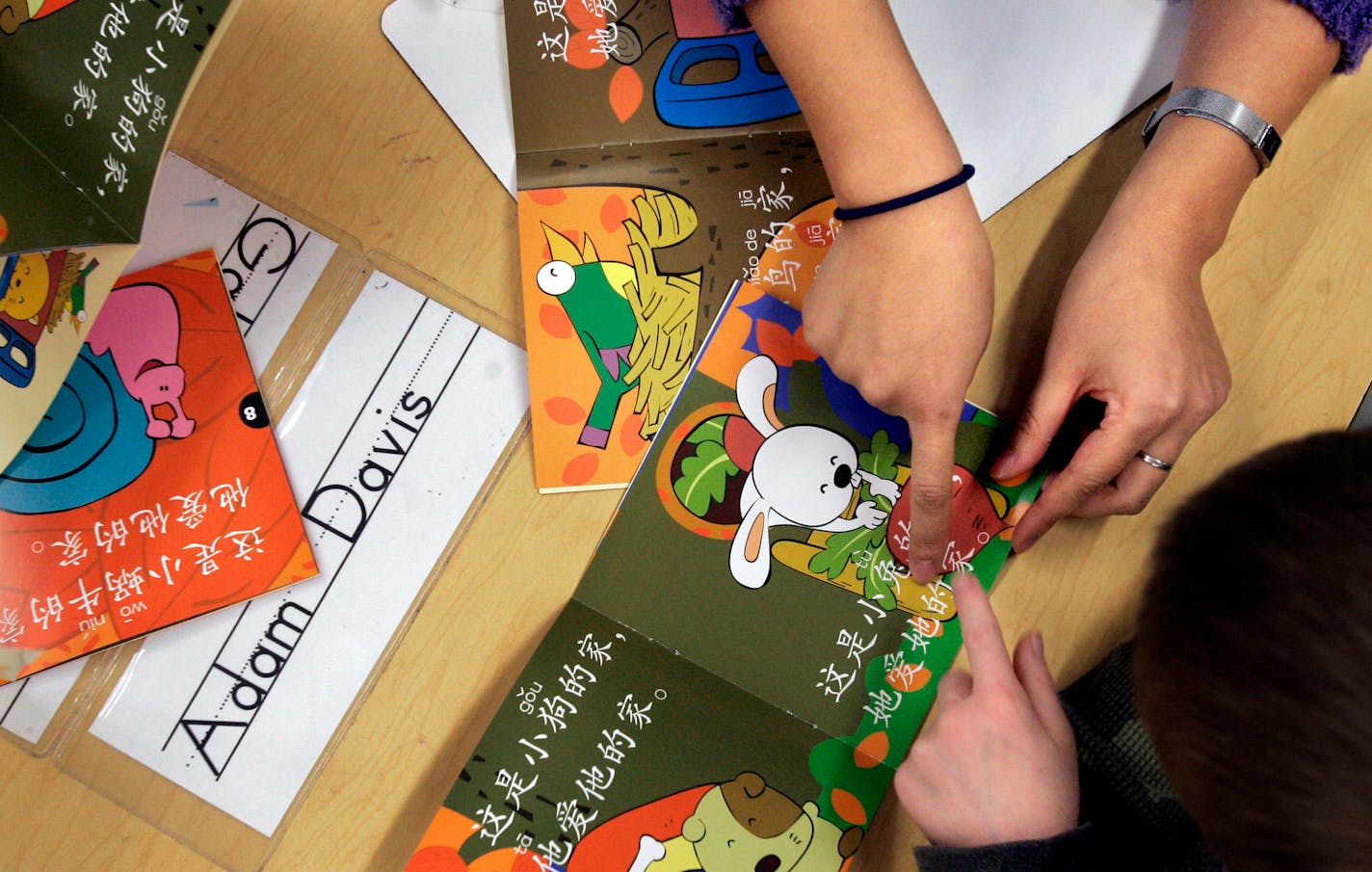 Kindergartners received help to read books in Mandarin. Teachers use gestures, pictures and more to help the kids get the ideas. "It's the same as regular kindergarten classes," said Excelsior Principal Lee Drolet.