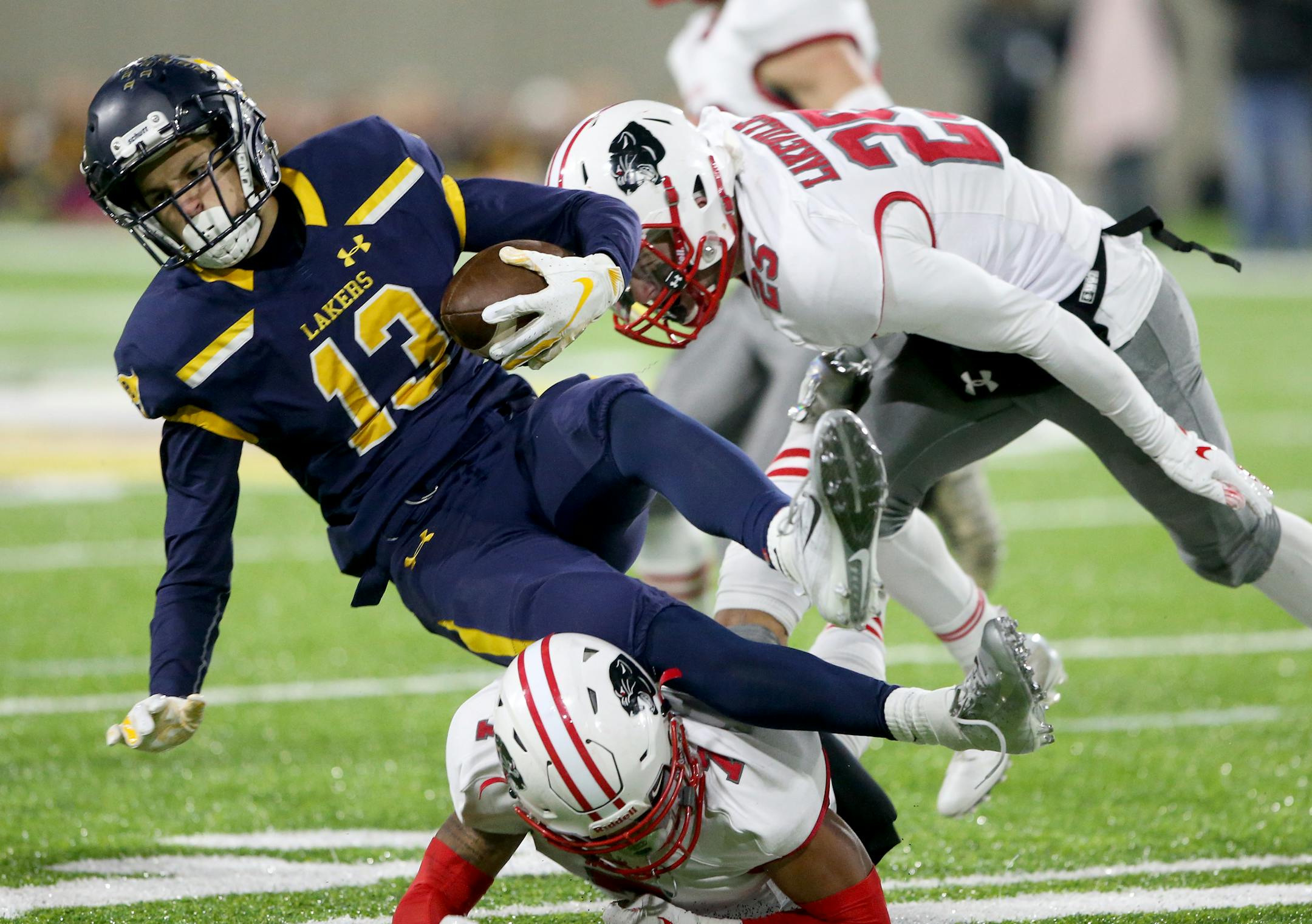 Prior Lake receiver Spencer Marlier was upended by Lakeville North defensive back RaJa Nelson after catching a pass during the first half Friday at TCO Stadium in Eagan.
