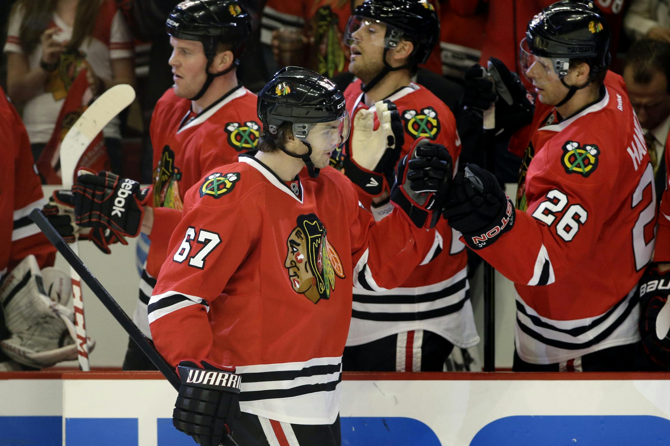 Chicago Blackhawks' Michael Frolik (67) celebrates with teammates after scoring a goal during the first period of Game 2 of an NHL hockey Stanley Cup first-round playoff series against the Minnesota Wild in Chicago, Friday, May 3, 2013. (AP Photo/Nam Y. Huh)