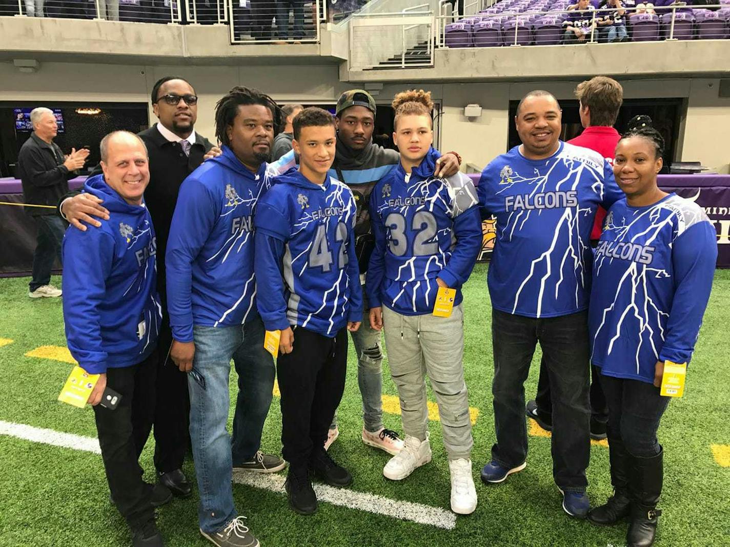 Phelps Falcons celebrating the free Super Bowl tickets include, from left in the Falcons gear: Pastor Jim Halbur, Coach Darrell Johnson, Zaevion and Isaiah Henderson, Coach Marcus Nolen and the boys' aunt Telyse Henderson. ORG XMIT: c31S6t87wTveeCqKobYm