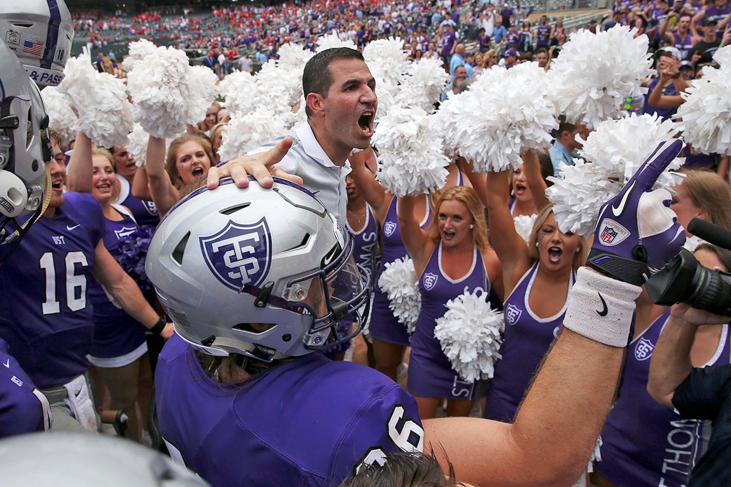 University of St. Thomas head football coach Glenn Caruso celebrated with his team after defeating St. John's in 2017 at Target Field.