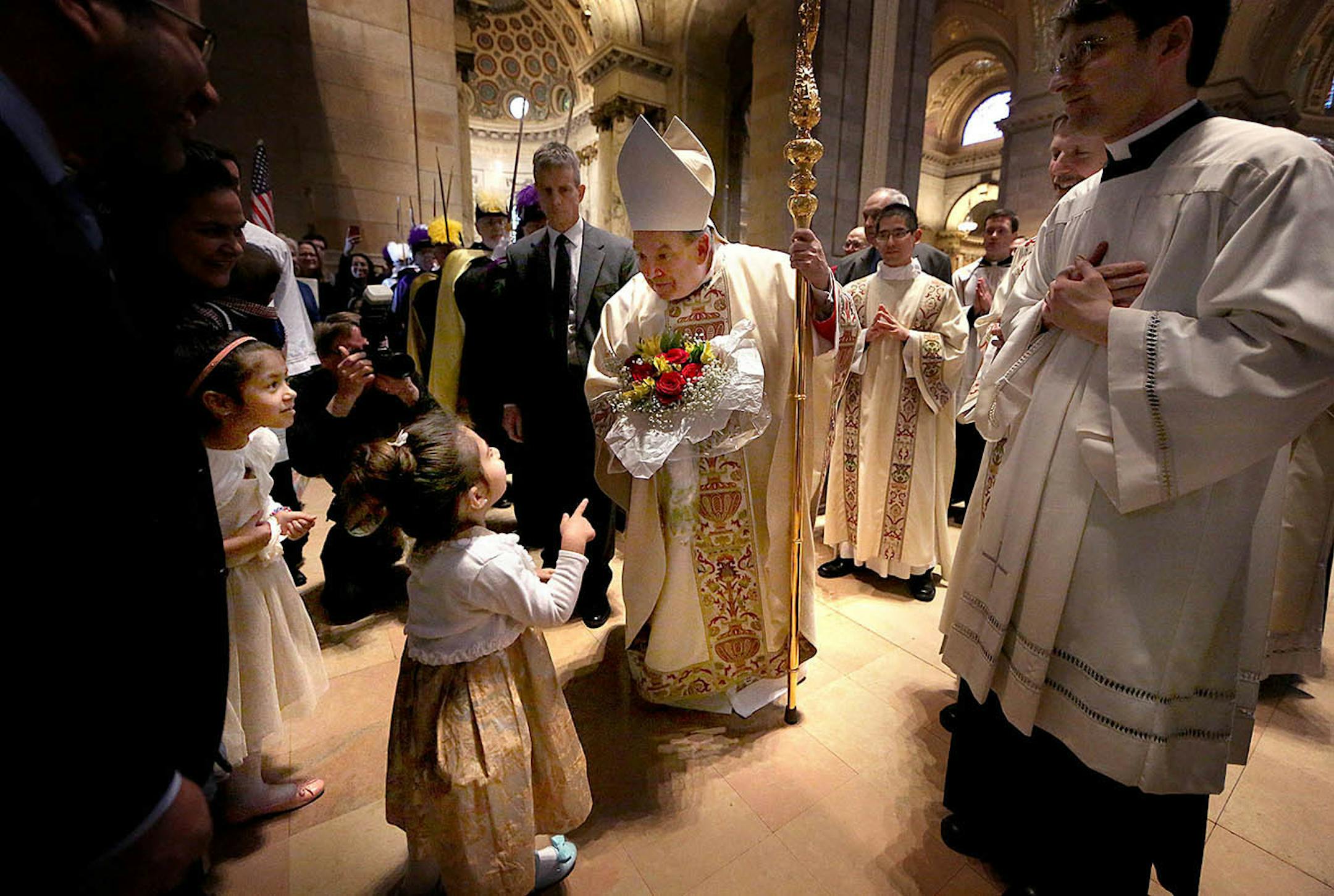 Archbishop Bernard Hebda was greeted by faithful, including several children, at the conclusion of a Mass of Installation at the Cathedral of St. Paul.