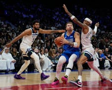 Luka Doncic of Dallas drove to the basket on Timberwolves guard Nickeil Alexander-Walker on Saturday in Abu Dhabi.