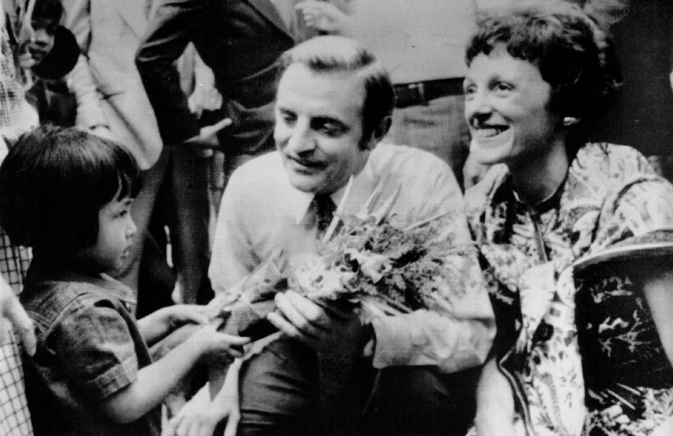 May 5, 1978 A Small Gift -- U.S. Vice President Walter Mondale and his wife Joan kneel down to receive a bouquet of flowers from a little Vietnamese refugee girl during a visit to a refugee transit camp in Bangkok, Thailand, Friday. Mondale said the U.S. would accept 25,000 more refugees a year from Vietnam, Laos and Cambodia. May 6, 1978 AP Laserphoto ORG XMIT: MIN2017012521343798