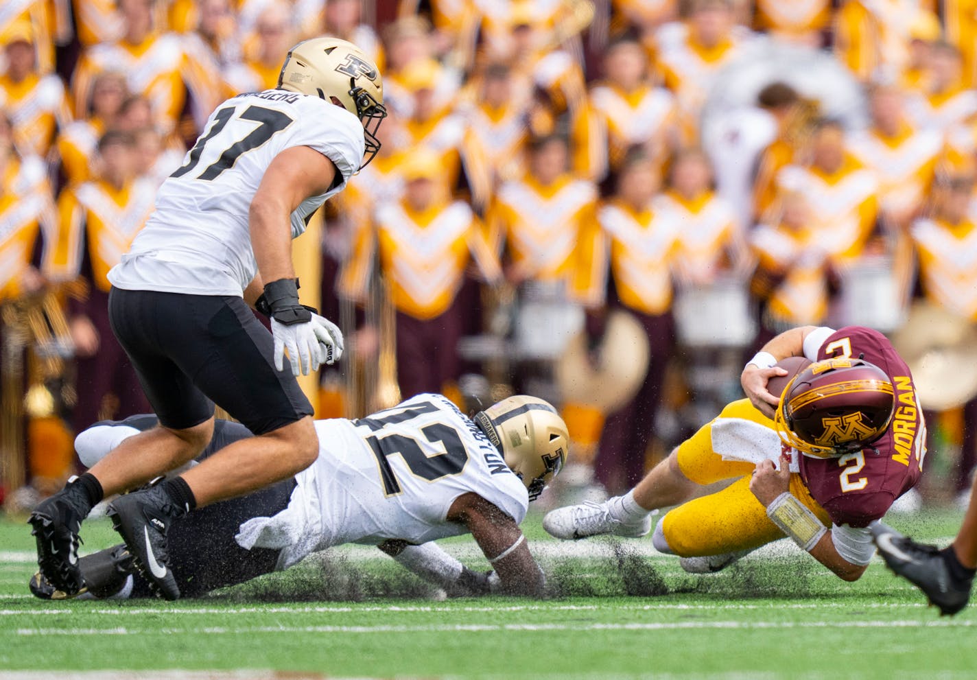 Minnesota Gophers quarterback Tanner Morgan (2) is tackled by Purdue Boilermakers linebacker Clyde Washington (42) in the fourth quarter Saturday, Oct. 1, 2022 at Huntington Bank Stadium in Minneapolis, Minn. ]