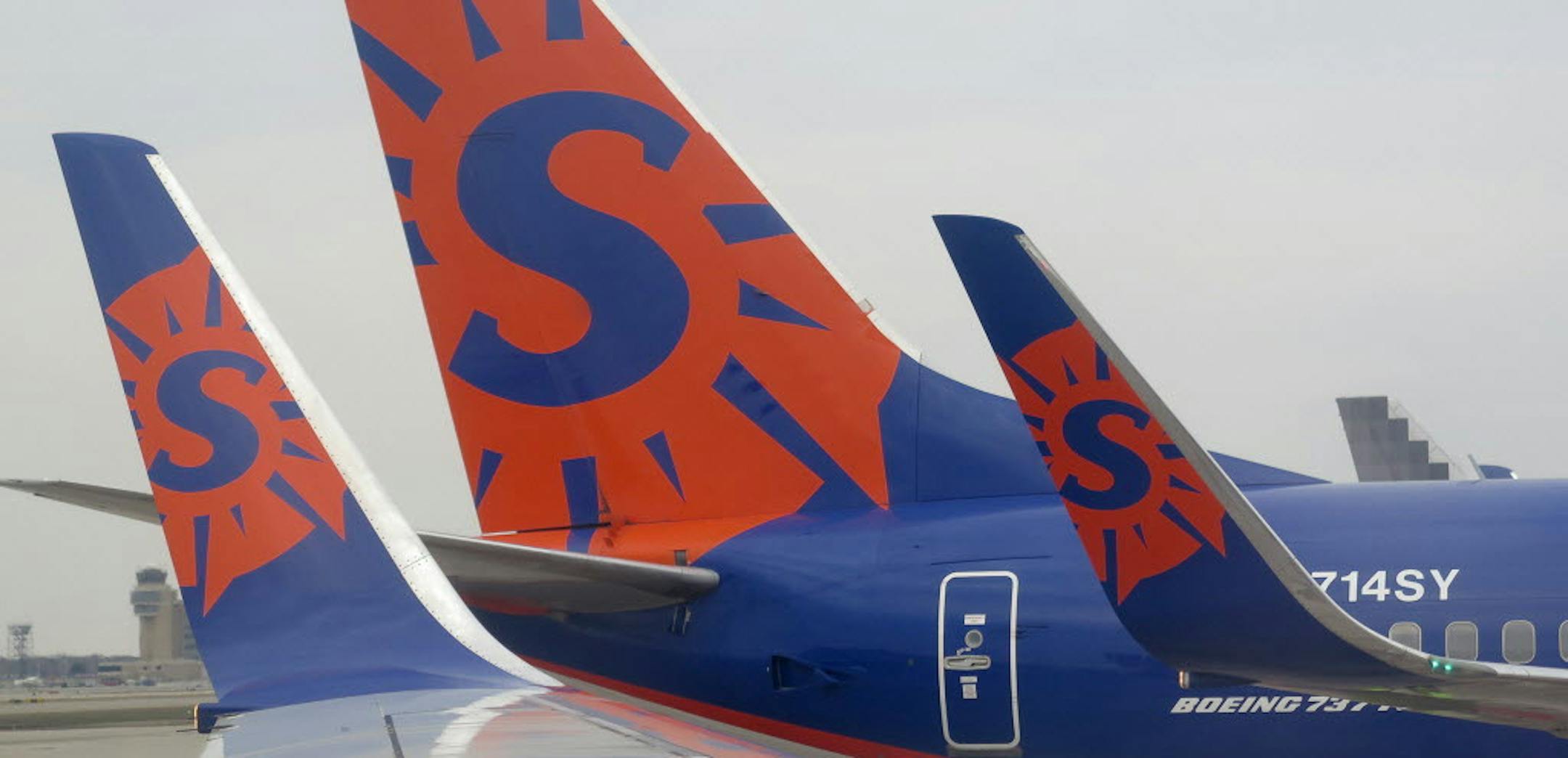 Sun Country airlines logo on 737 wing tips and tail at Humphrey terminal at the Minneapolis-St. Paul International Airport.