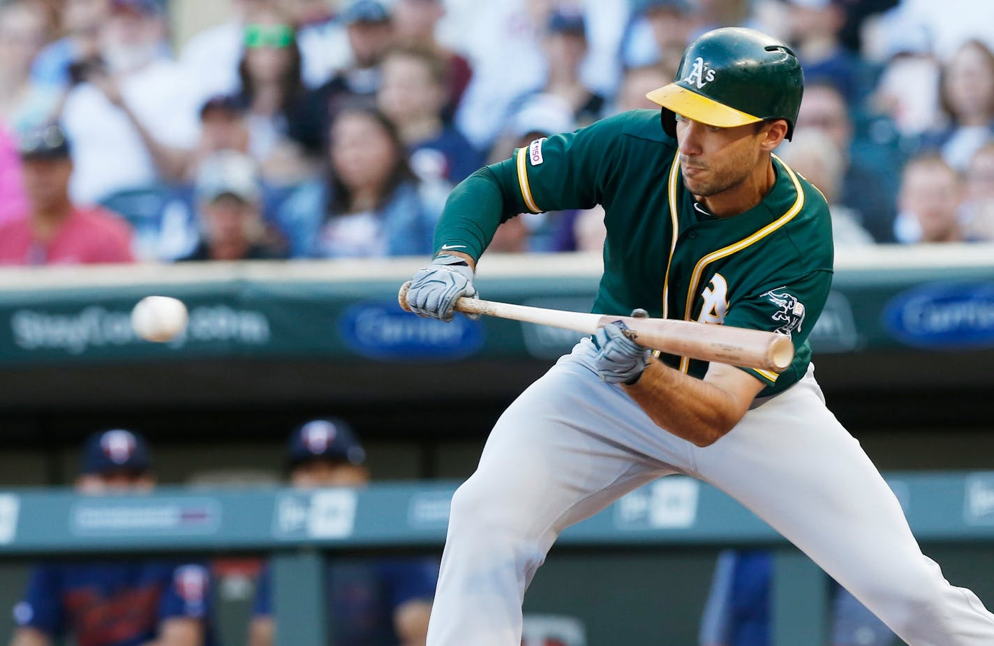 Oakland Athletics' Matt Olson lays down a successful bunt off Minnesota Twins pitcher Jose Berrios in the first inning of a baseball game Saturday, July 20, 2019, in Minneapolis. (AP Photo/Jim Mone)