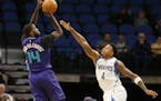 Charlotte Hornets' Michael Kidd-Gilchrist shoots over Minnesota Timberwolves' Brandon Rush during the first quarter of an NBA preseason basketball gam