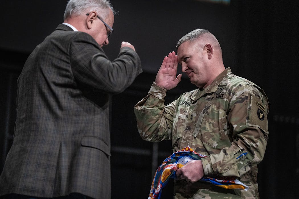 Minnesota Gov. Tim Walz, left, presented the Minnesota state flag to Maj. Gen. Charles Kemper during deployment ceremonies for 550 members of the Minnesota National Guard’s 34th Infantry Division “Red Bulls” at Grace Church in Eden Prairie on Thursday. They're heading to Kuwait in one of the Minnesota National Guard's largest deployments since the end of the Iraq War.