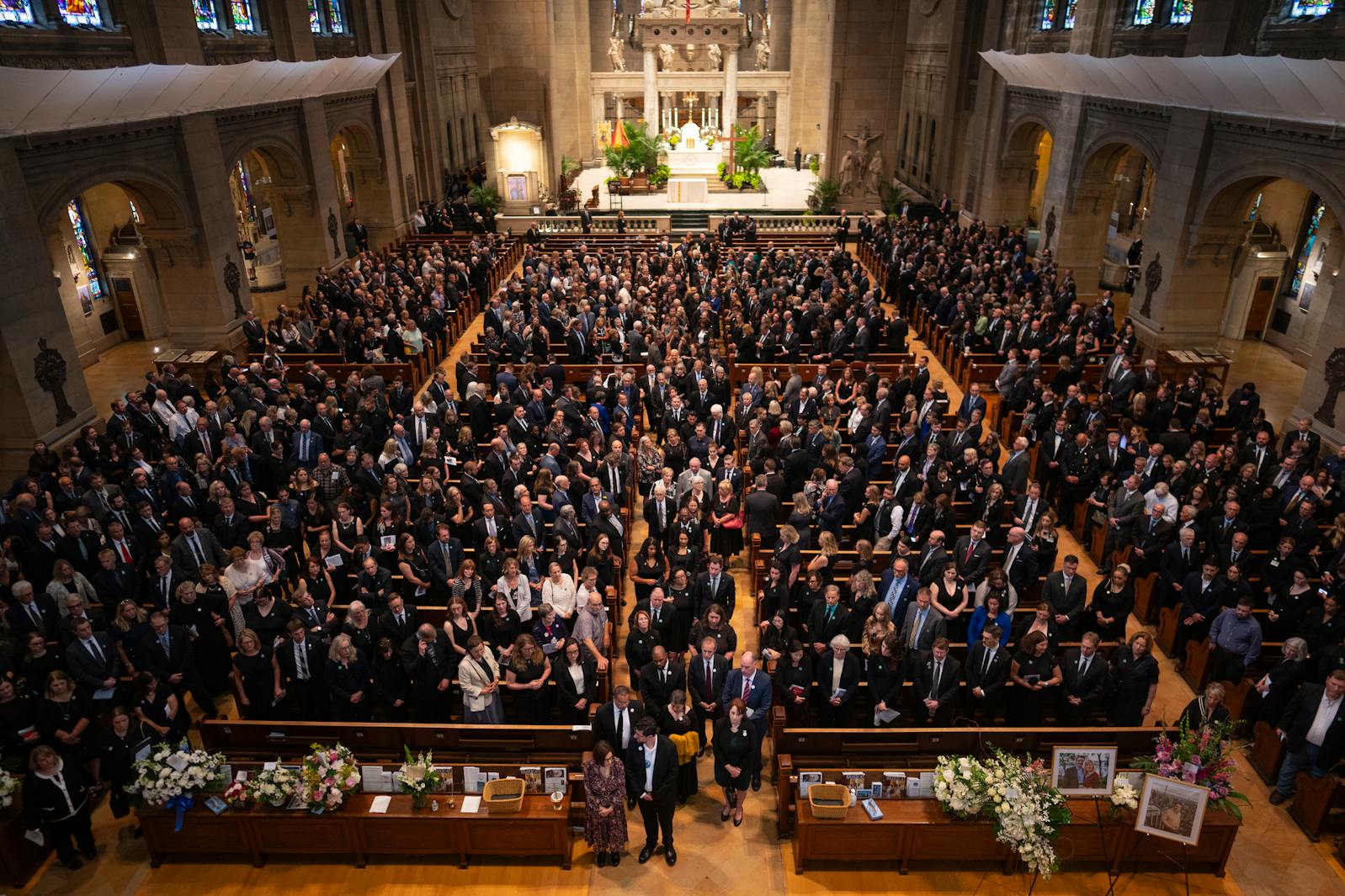 Guests pause before leaving the church following the funeral for Rep. Melissa Hortman and her husband, Mark Hortman, at the Basilica of St. Mary in Minneapolis on Saturday.