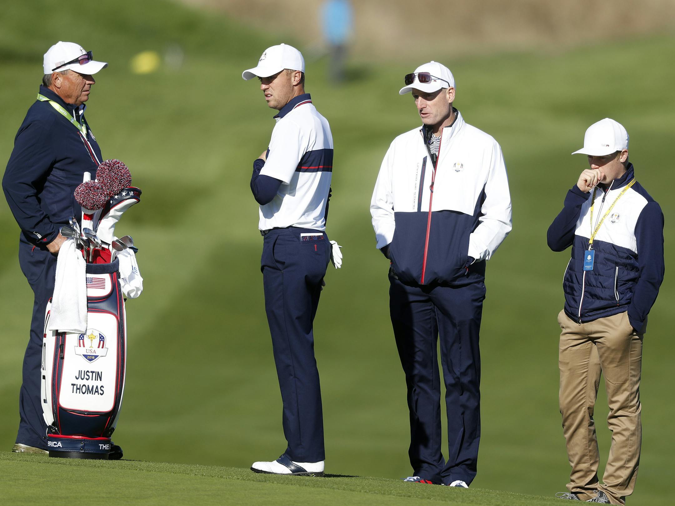 US team captain Jim Furyk, second right, stands with Justin Thomas of the US, second left, during a practice round at Le Golf National in Guyancourt, outside Paris, France, Tuesday, Sept. 25, 2018. The 42nd Ryder Cup will be held in France from Sept. 28-30, 2018 at Le Golf National. (AP Photo/Alastair Grant)