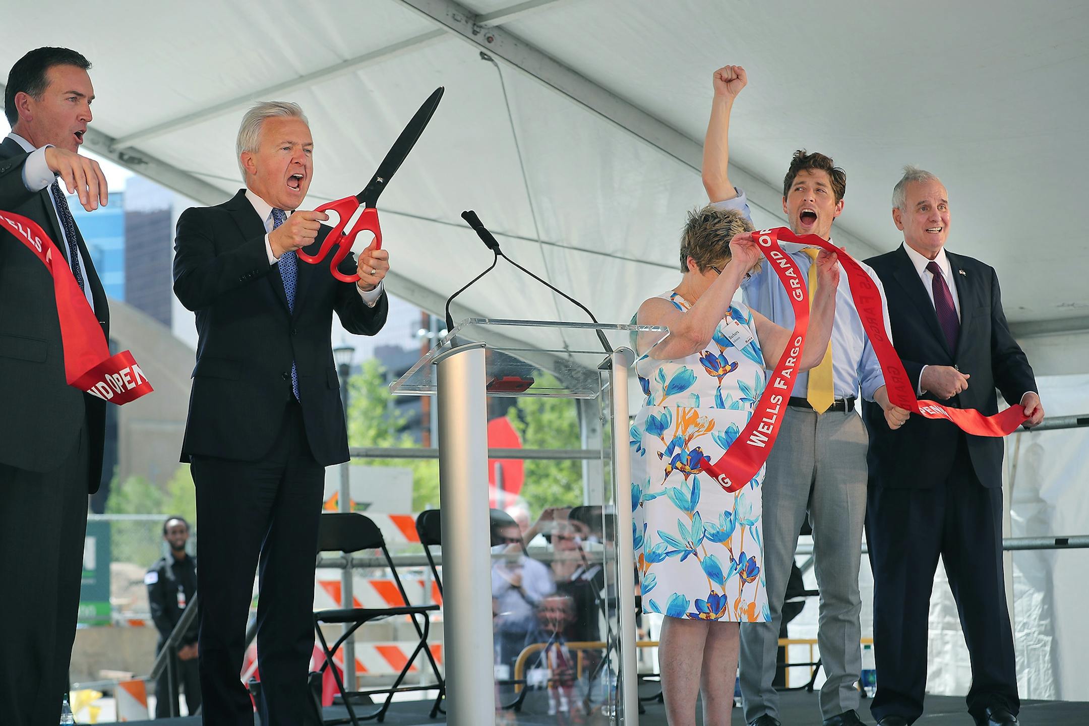 Wells Fargo Minnesota CEO Dave Kvamme, from left, Wells Fargo Chairman and CEO John Stumpf, Minneapolis City Council President Barb Johnson, Minneapolis Council Member Jacob Frey, and Minnesota Gov. Mark Dayton, celebrated after cutting a ribbon to ring in the grand opening of Minneapolis East Town Towers, Wednesday, July 20, 2016 in downtown Minneapolis, MN.