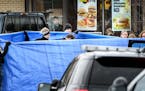 Burnsville Police held a tarp around the body as BCA investigators and Medical Examiners investigated a shooting that occured in a McDonald's parking 