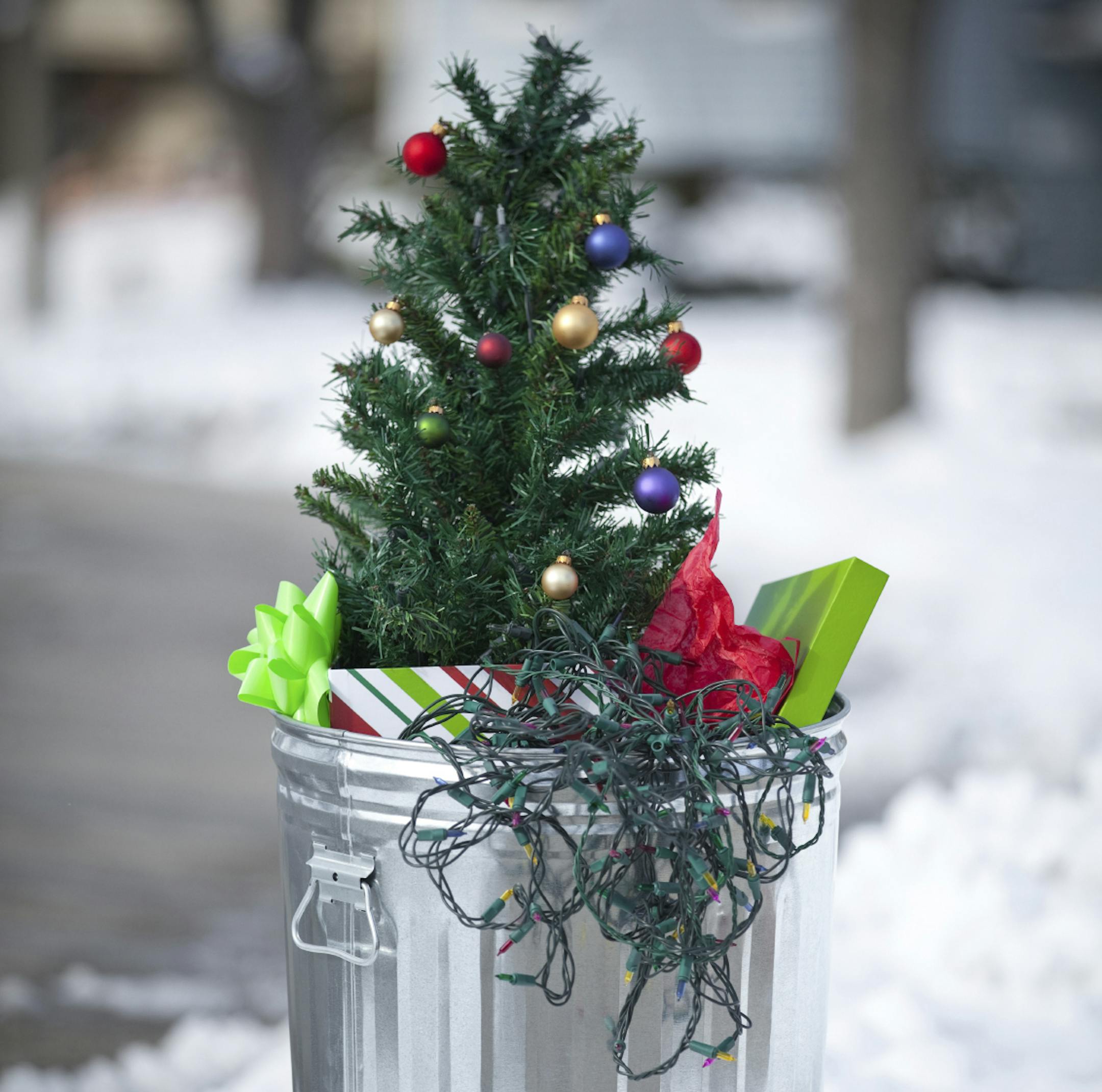 Christmas is over. Xmas tree, gifts, wrapping paper and lights in the trash ORG XMIT: MIN2012122614565983