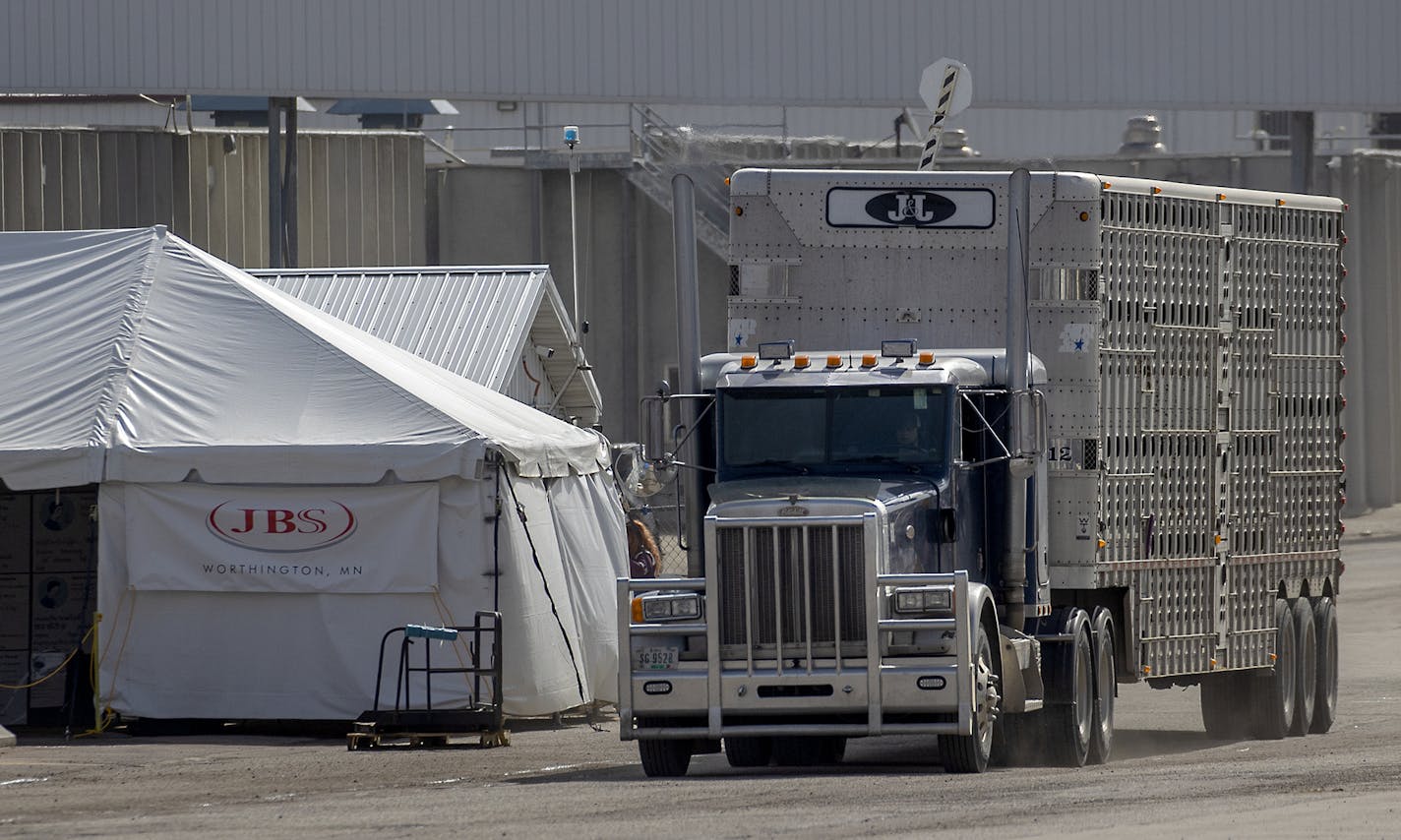 A tent has been set outside the entrance at JBS meatpacking plant in Worthington, Minn., to screen employees.