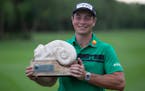 Viktor Hovland holds up the trophy after winning the Mayakoba Golf Classic in Playa del Carmen, Mexico