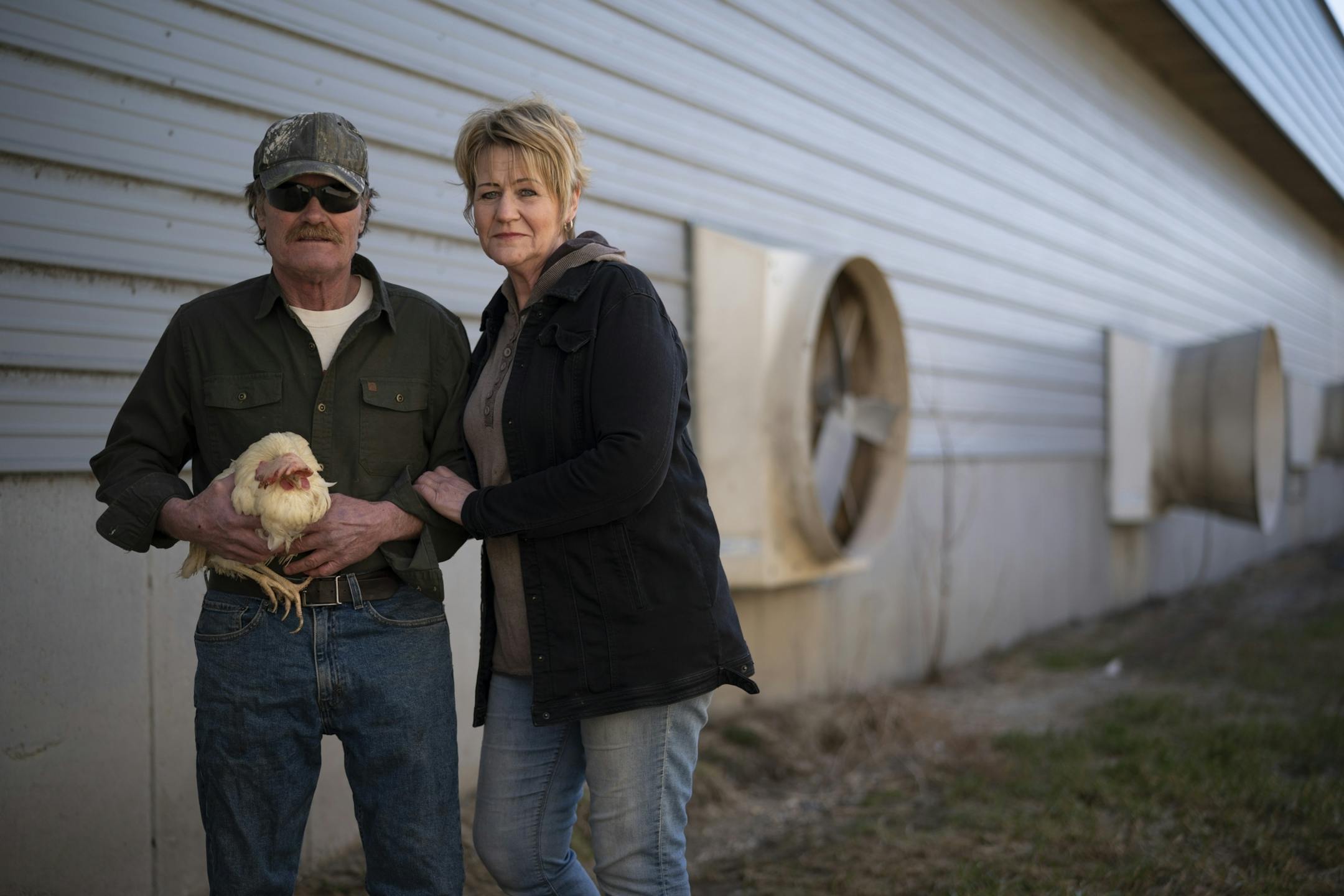 Kerry and Barb Mergen outside their now empty chicken house with a straggler who managed to elude the crew that came in just before Easter to euthanize the other 61,000 laying hens in their flock.