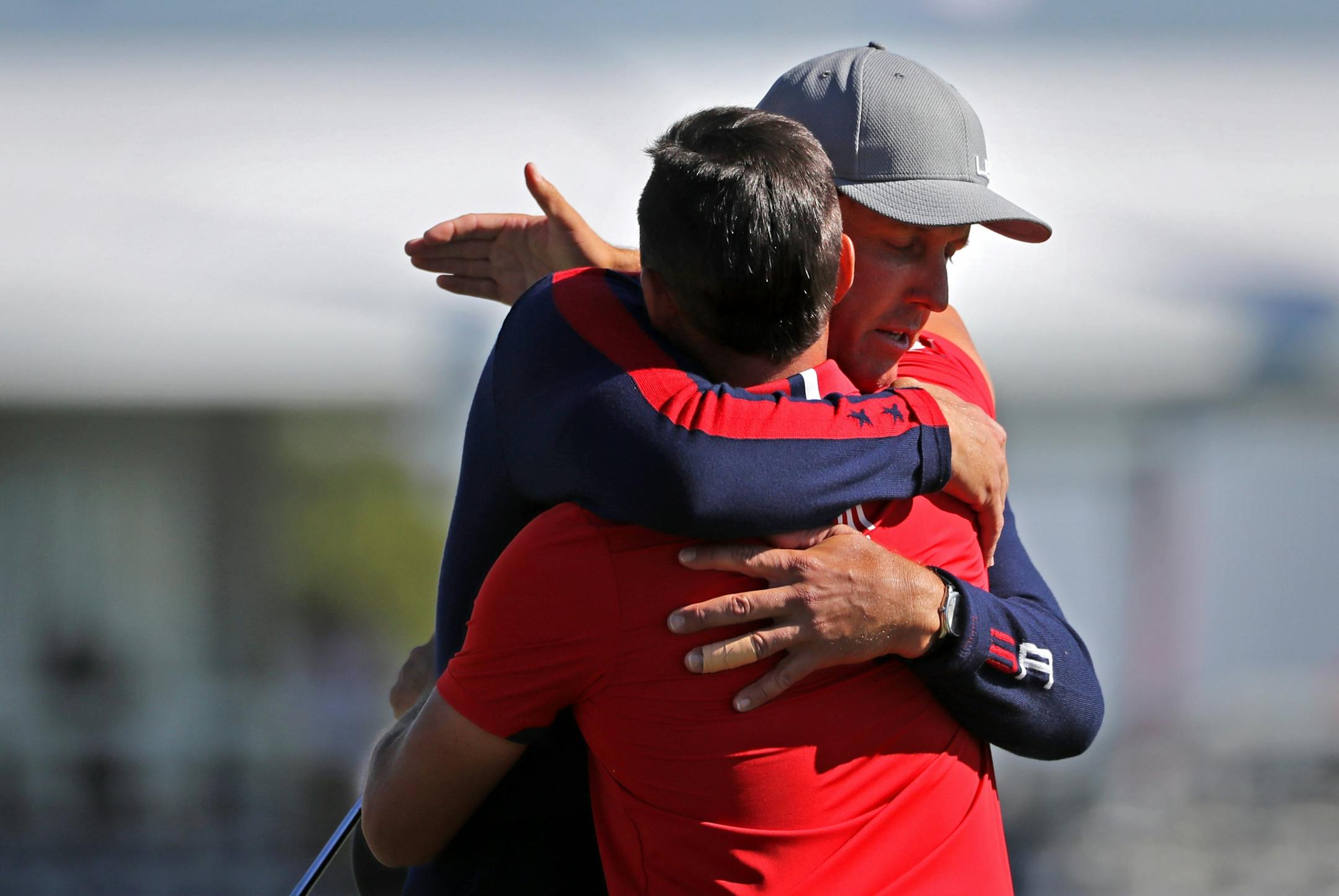 Team USA�s Phil Mickelson and teammate Ricky Fowler embrace after beating Rory McIlRoy and Andy Sullivan in the morning matches.