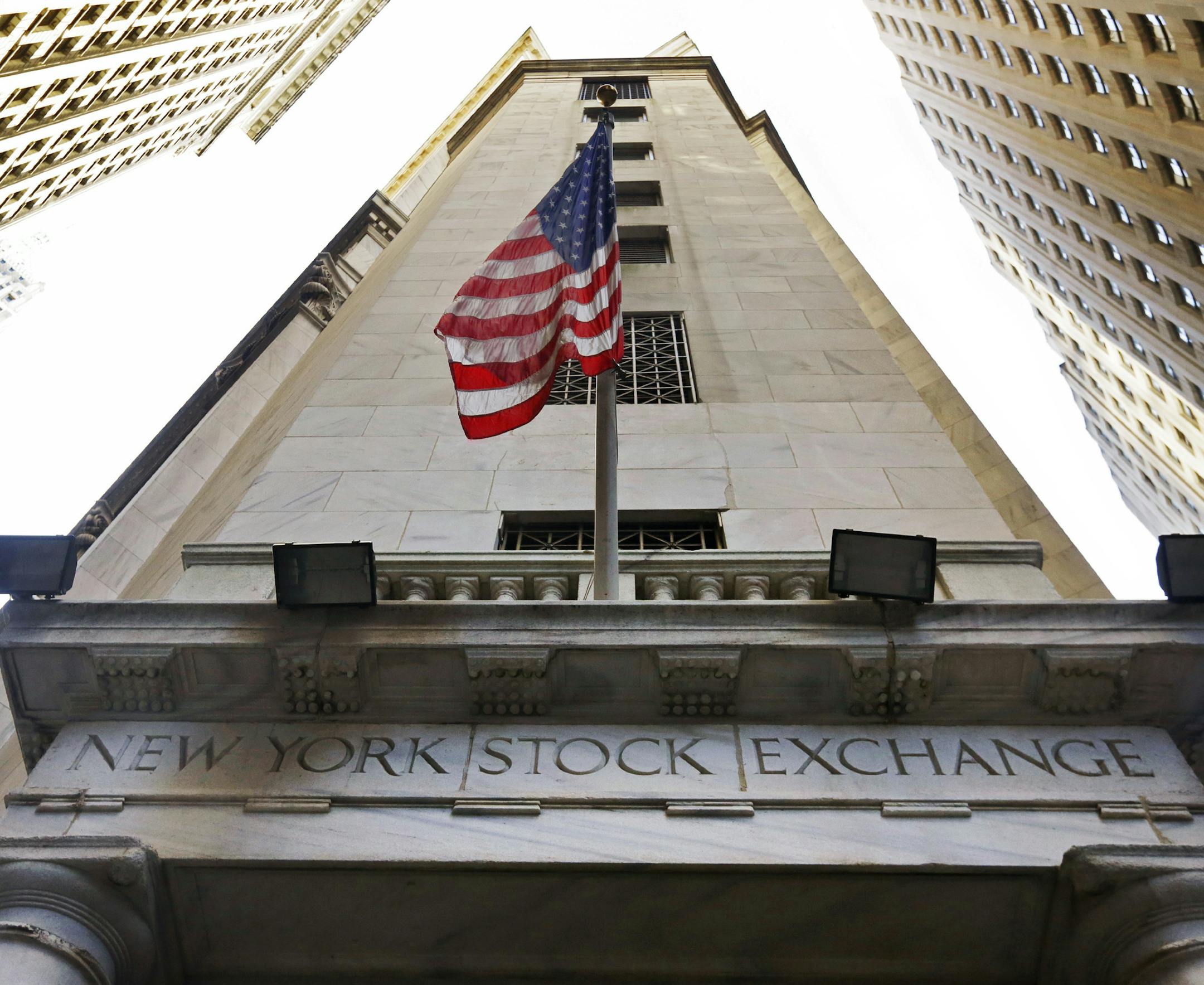 FILE - In this Friday, Nov. 13, 2015, file photo, the American flag flies above the Wall Street entrance to the New York Stock Exchange. Stocks are opening moderately higher on Wall Street on Thursday, June 30, 2016, as traders feel less anxious about Britain's vote a week earlier to leave the European Union. (AP Photo/Richard Drew, File)