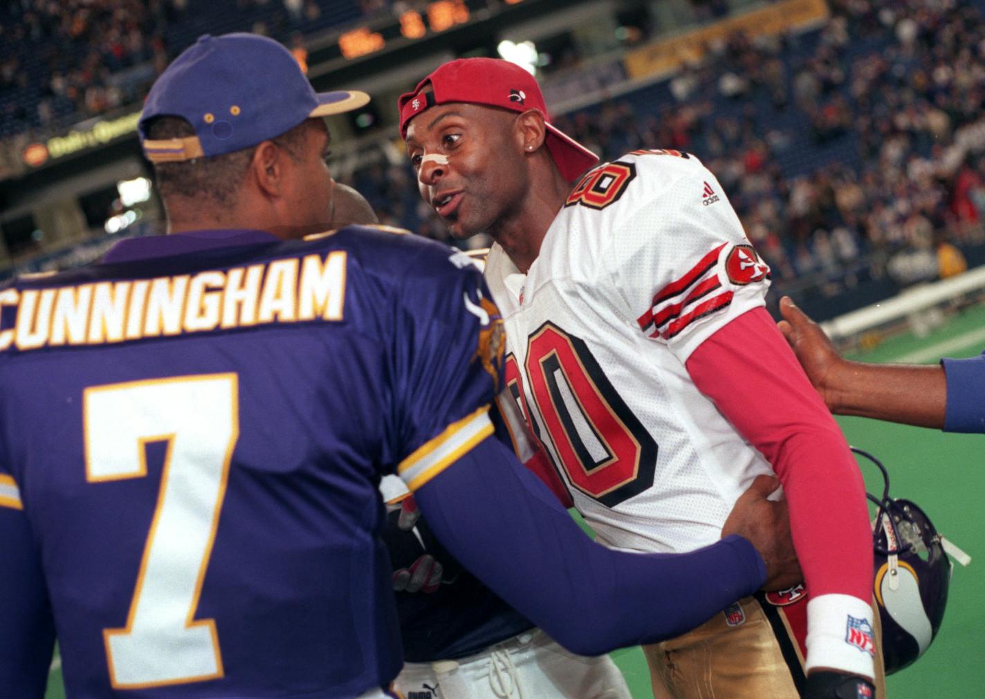 Minneapolis, MN 19/24/99 -Vikings against the 49ers at the Metrodome. -- Viking quarterback Randall Cunningham, left, and Forty-Niner receiver Jerry Rice, right, greet each other at midfield at the end of the game at the Metrodome Sunday. The Vikings won the game easily, but Cunningham did not play, having been replaced by quarterback Jeff George. ORG XMIT: MIN2013122601094232