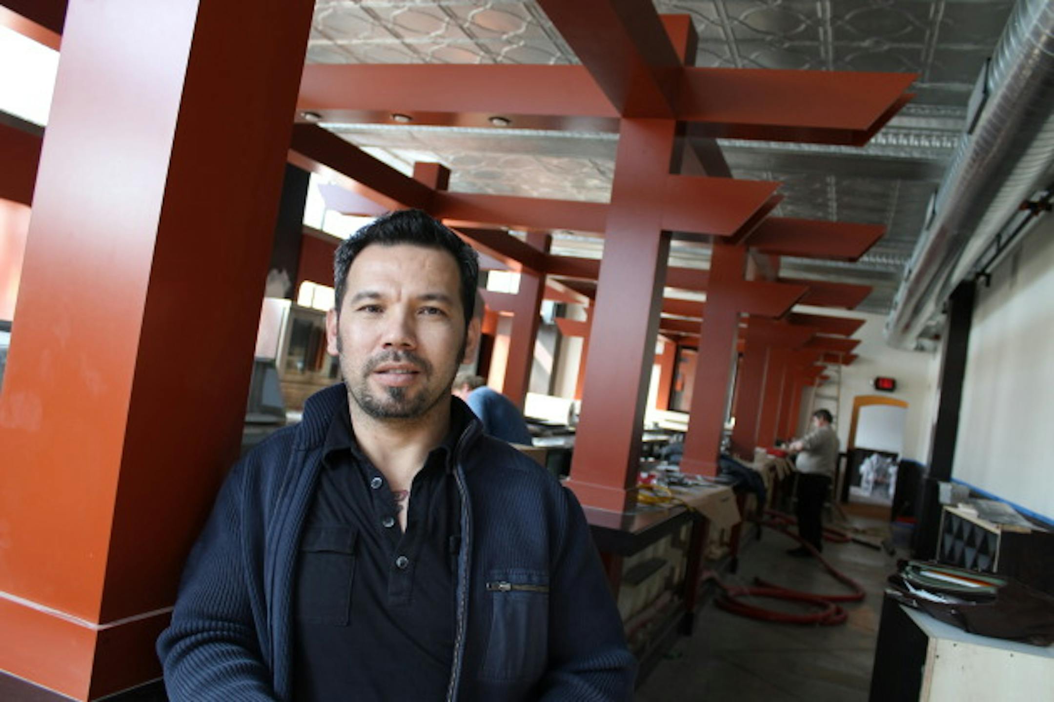 Thom Pham showed off the new bar Tuesday at Azia Market. Photo by Tom Horgen.
