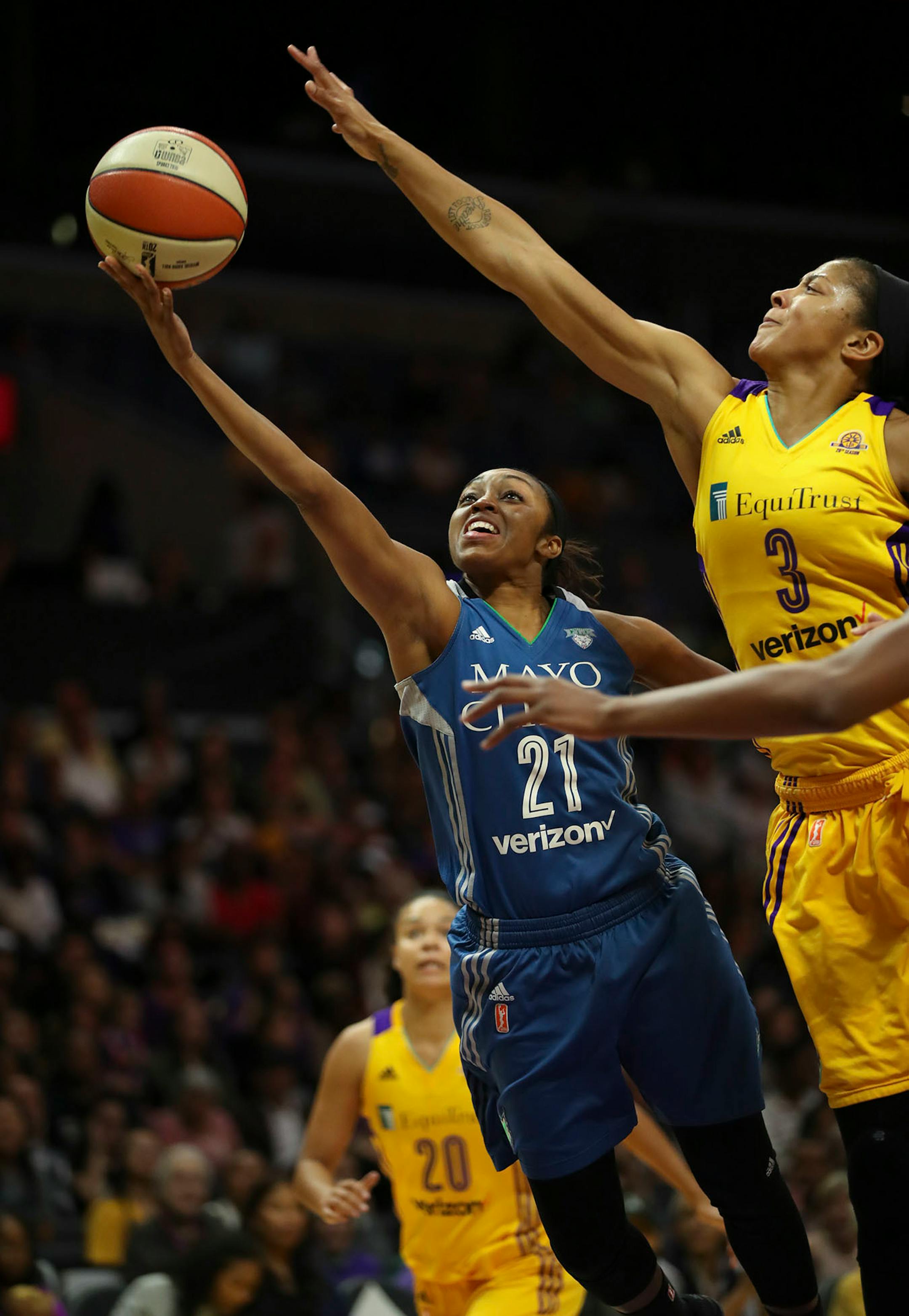Minnesota Lynx guard Renee Montgomery (21) shot in the first quarter under the defense of Los Angeles Sparks forward Candace Parker (3).