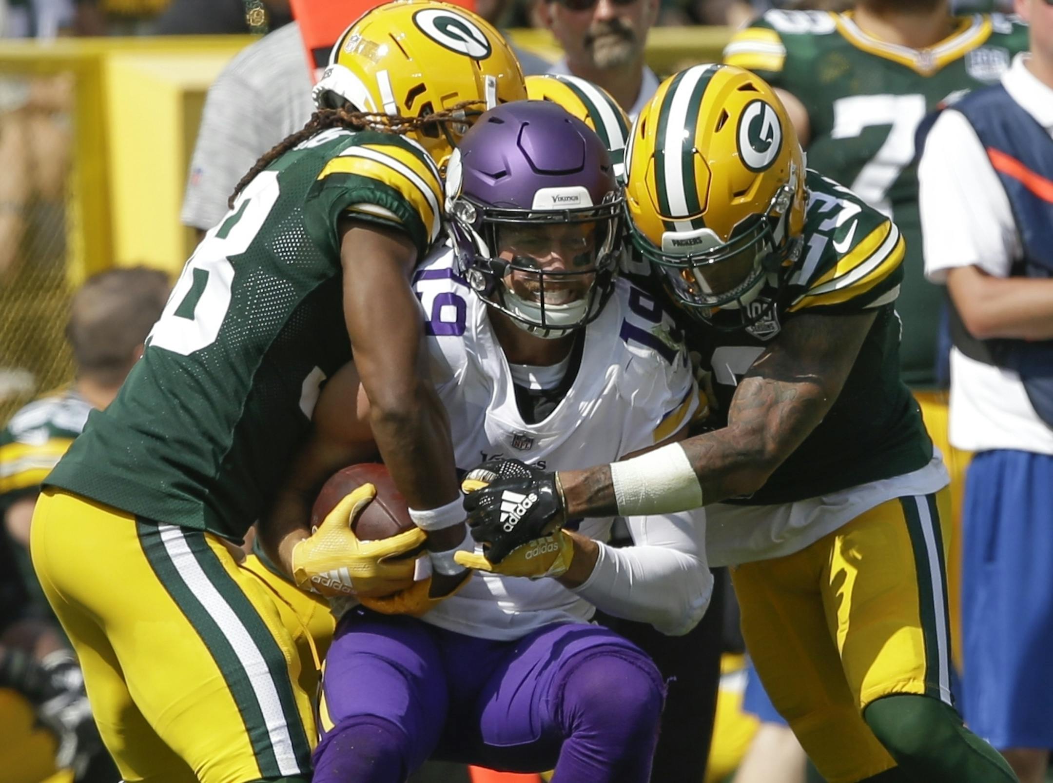 Minnesota Vikings' Adam Thielen catches a pass between Green Bay Packers' Tramon Williams and Jaire Alexander during the first half of an NFL football game Sunday, Sept. 16, 2018, in Green Bay, Wis. (AP Photo/Jeffrey Phelps)