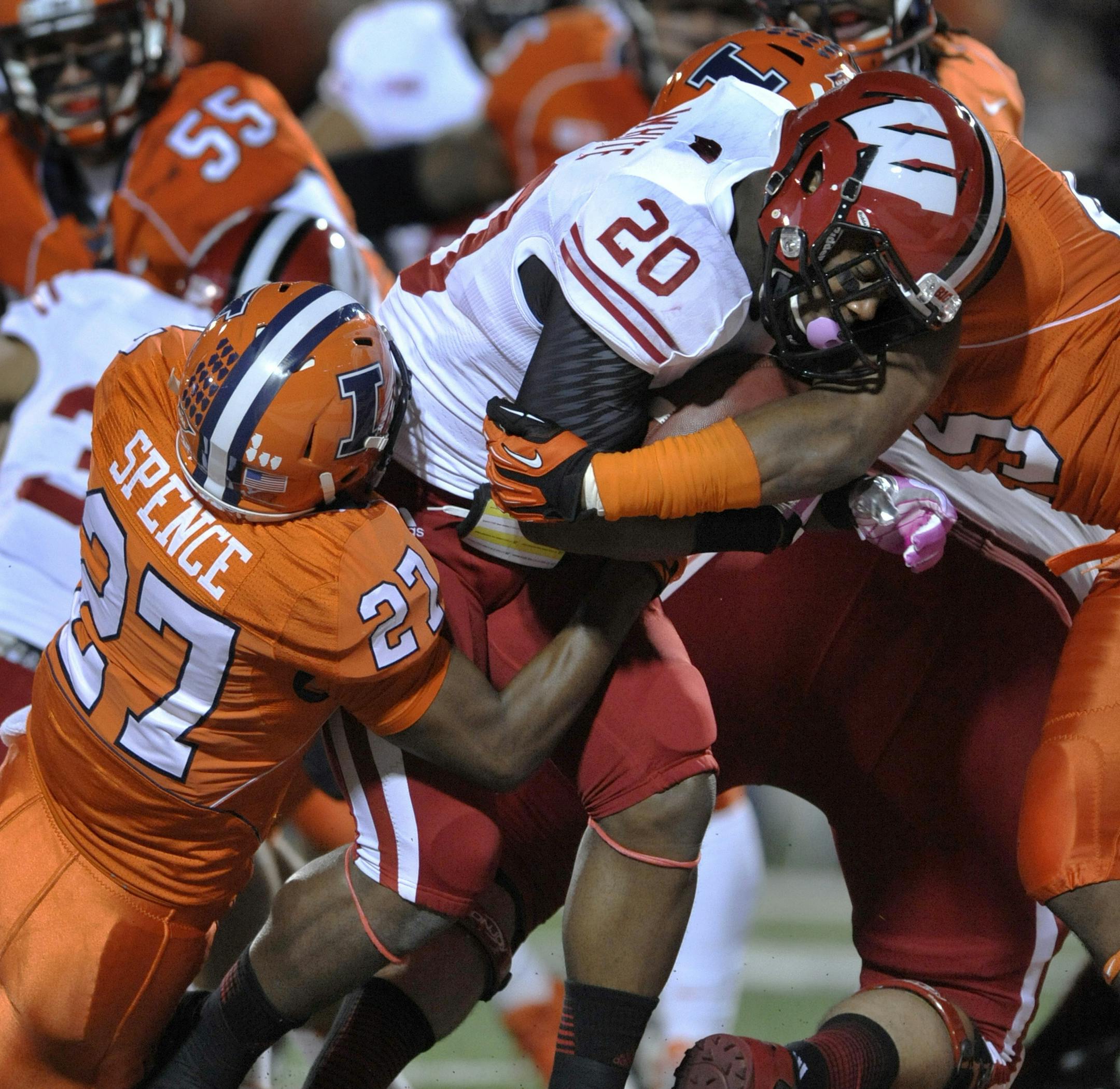 Wisconsin running back James White (20), rushes for a touchdown against Illinois' Eaton Spence (27), and Jonathan Brown (45), during the first quarter of NCAA college football game in Champaign, Ill., Saturday, Oct. 19, 2013. (AP Photo/Paul Beaty)