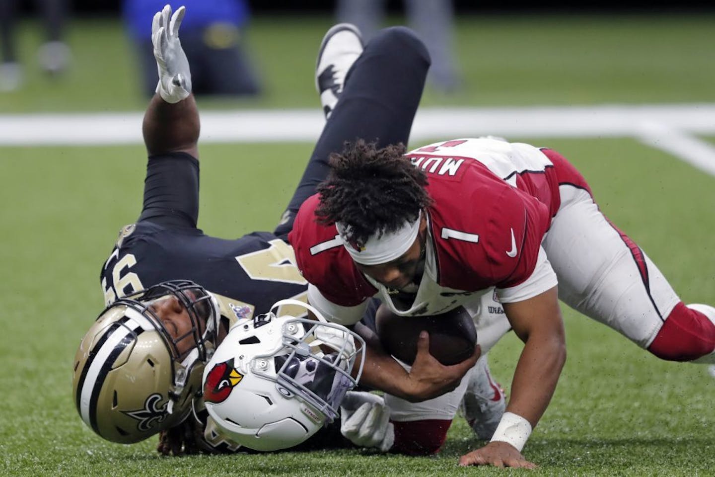 Arizona Cardinals quarterback Kyler Murray (1) loses his helmet after being tackled by Cam Jordan of the Saints earlier this season.