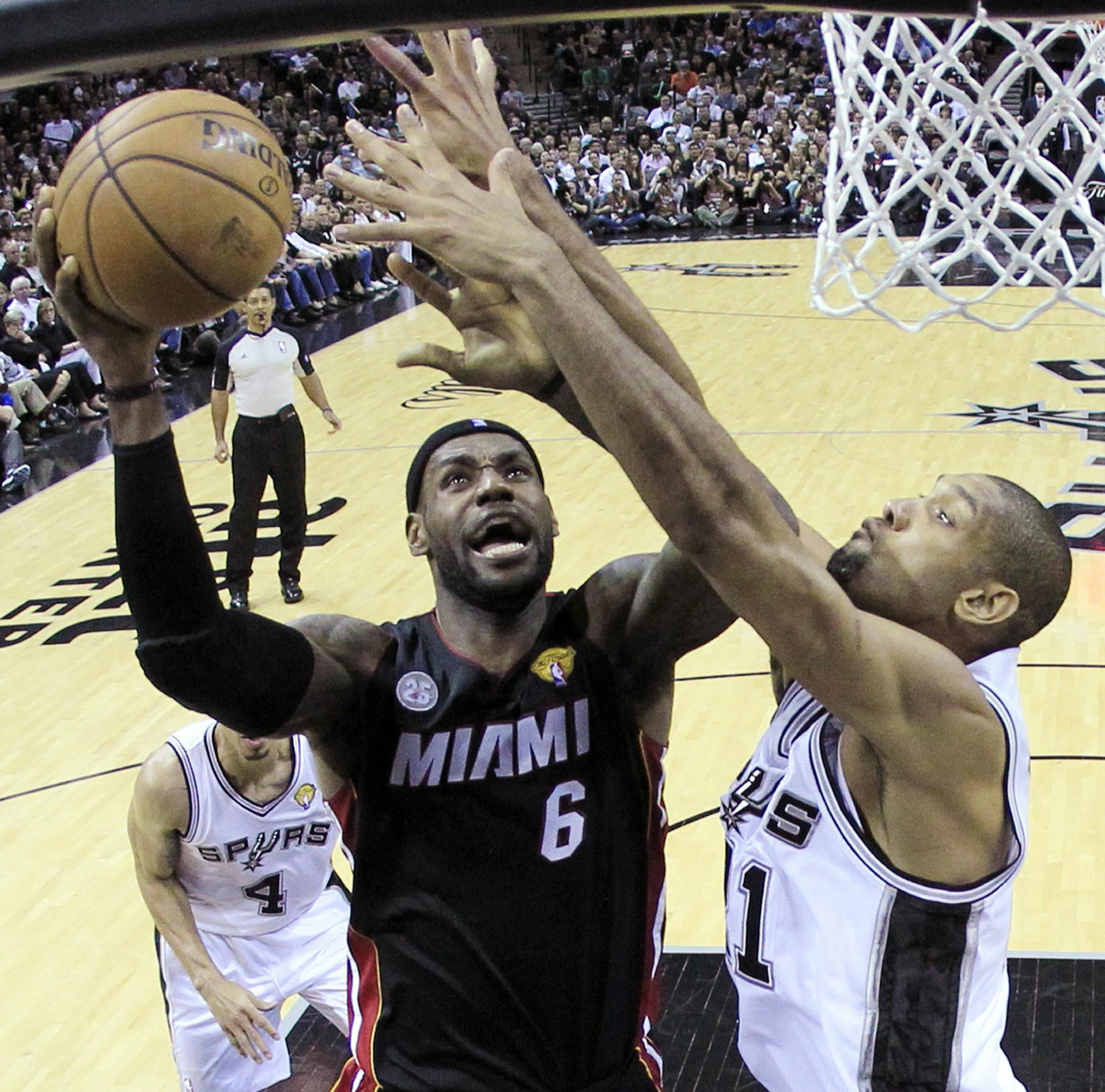 Miami Heat's LeBron James (6) shoots as San Antonio Spurs' Tim Duncan (21) defends during the first half at Game 4 of the NBA Finals basketball series, Thursday, June 13, 2013, in San Antonio. (AP Photo/Lucy Nicholson) ORG XMIT: TXKJ145