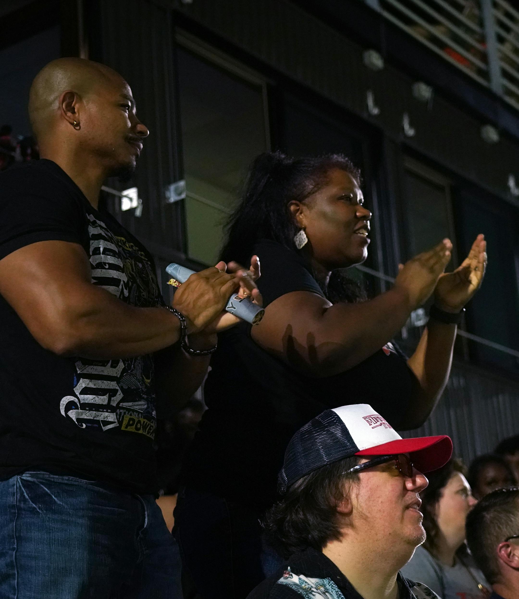 Minneapolis South alums Athena Garnett (right) and her brother Anthony cheered during the Tigers' homecoming football game. Athena's husband Eric Whipple is below in the hat. ] Shari L. Gross • shari.gross@startribune.com **THIS IS FOR PAULSEN'S SOUTH FEATURE** Minneapolis South hosted Washburn High School for a football game on Friday night, Sept. 20, 2019. South's homecoming was the first game played under the new stadium lights.