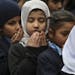 Pakistani students pray during a special ceremony for the victims of Tuesday's school attack in Peshawar, at a school in Lahore, Pakistan, Wednesday, 