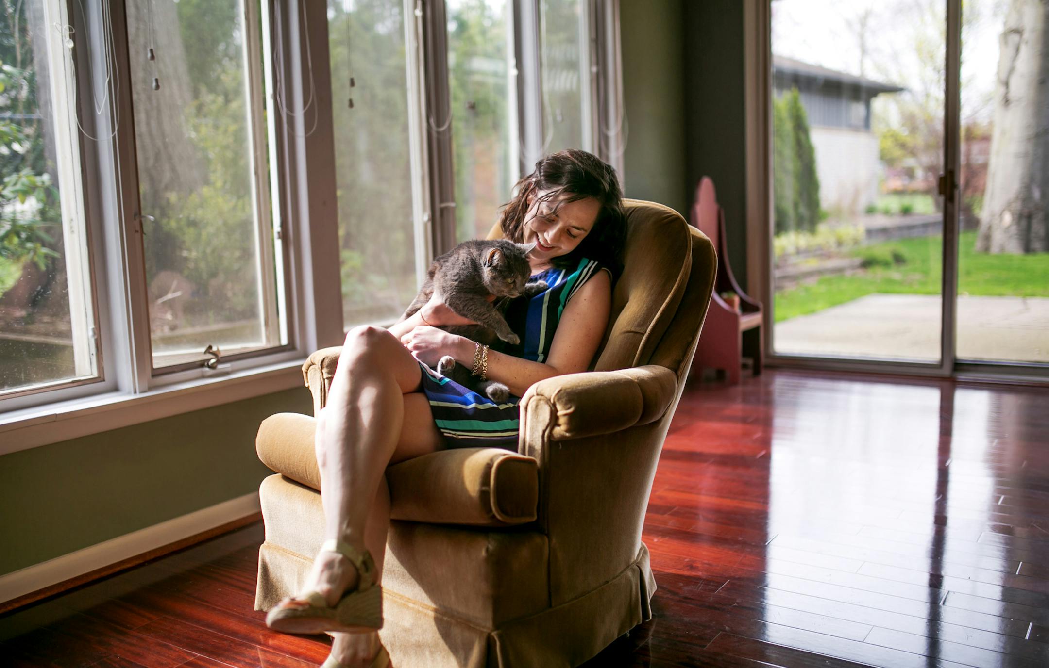 Hilary Lynch and her cat are photographed at her home in Farmington on April 18, 2017 that she purchased in February 2017 as her first home. (Ryan Garza/Detroit Free Press/TNS) ORG XMIT: 1201823