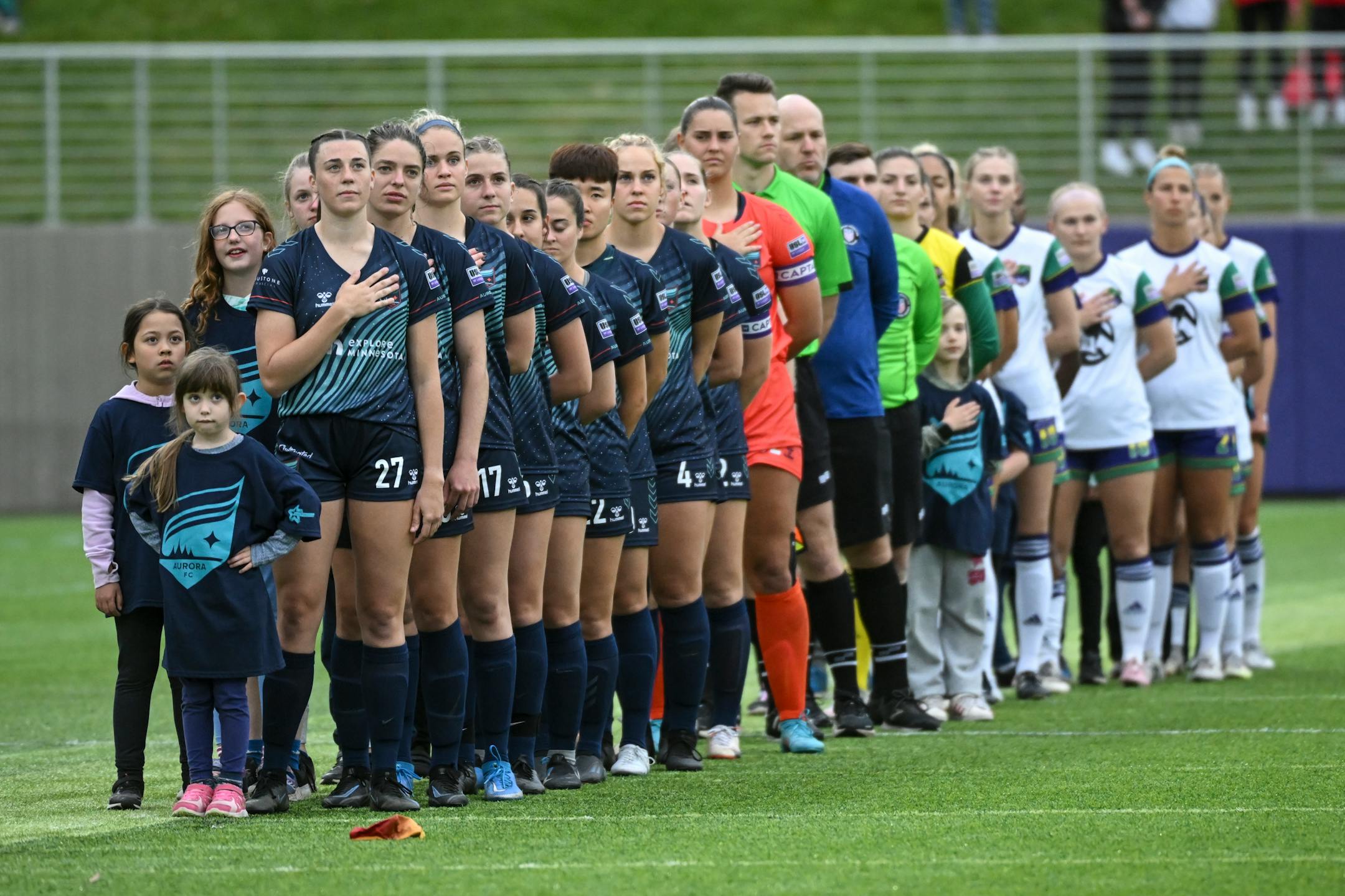 Minnesota Aurora players line up for the National Anthem before their match against the Green Bay Glory.