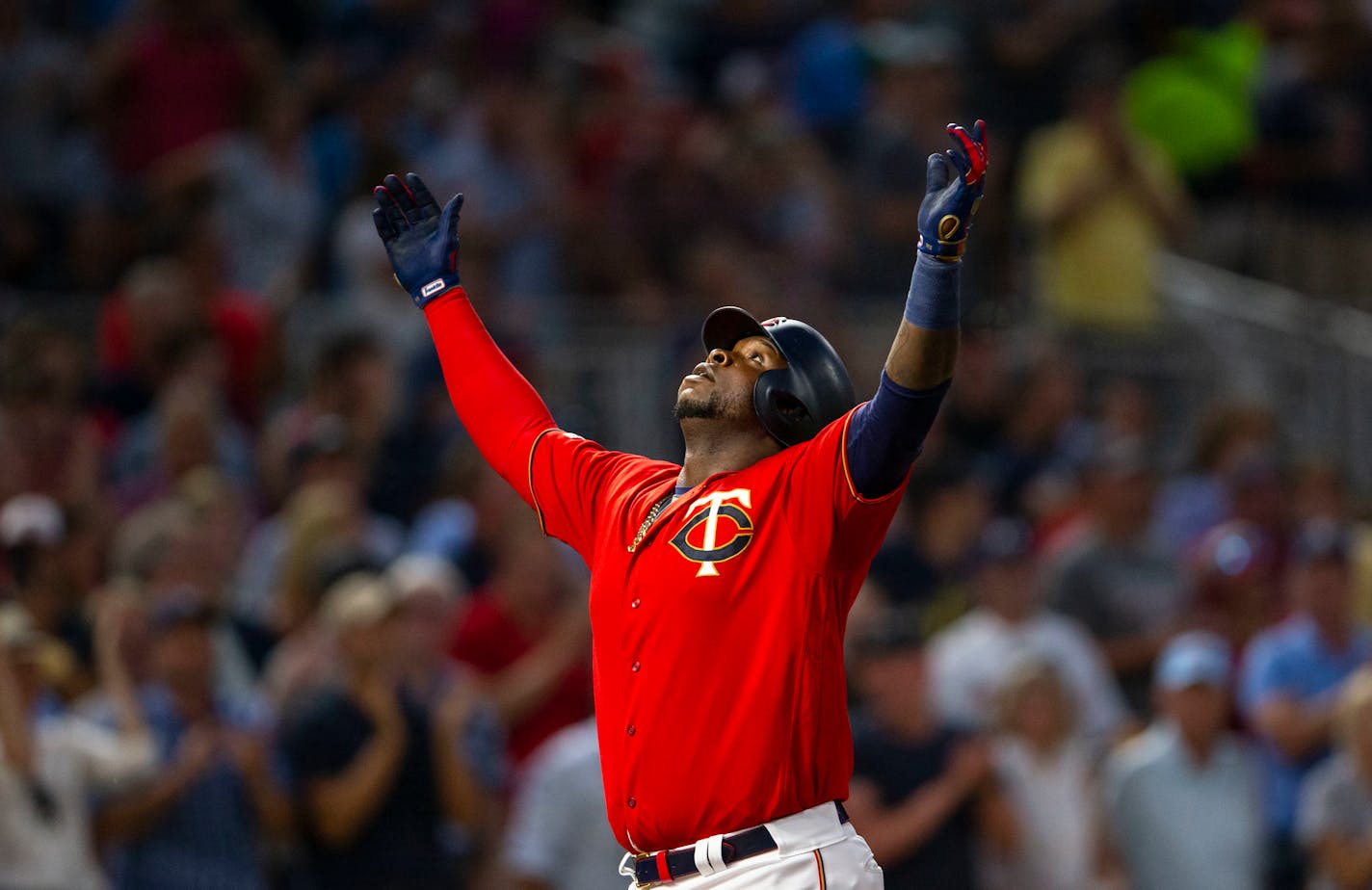 Twins third baseman Miguel Sano looks up to the sky in celebration after crossing home plate on his three-run home run in the bottom of the fourth inning