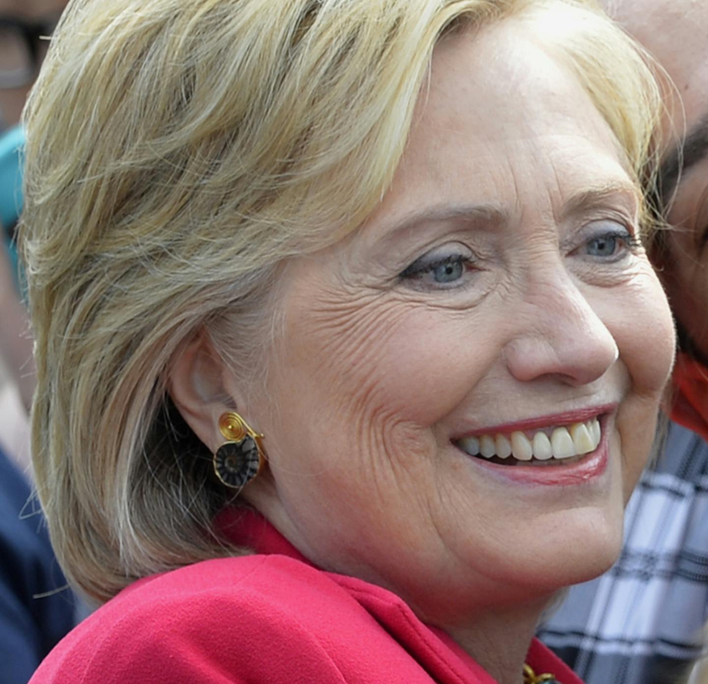 Democratic presidential candidate Hillary Rodham Clinton poses for a photo with two of her supporters on the campus of Case Western Reserve University in Cleveland, Thursday, Aug. 27, 2015, during a 'Commit to Vote' grassroots organizing meeting. (AP Photo/David Richard)